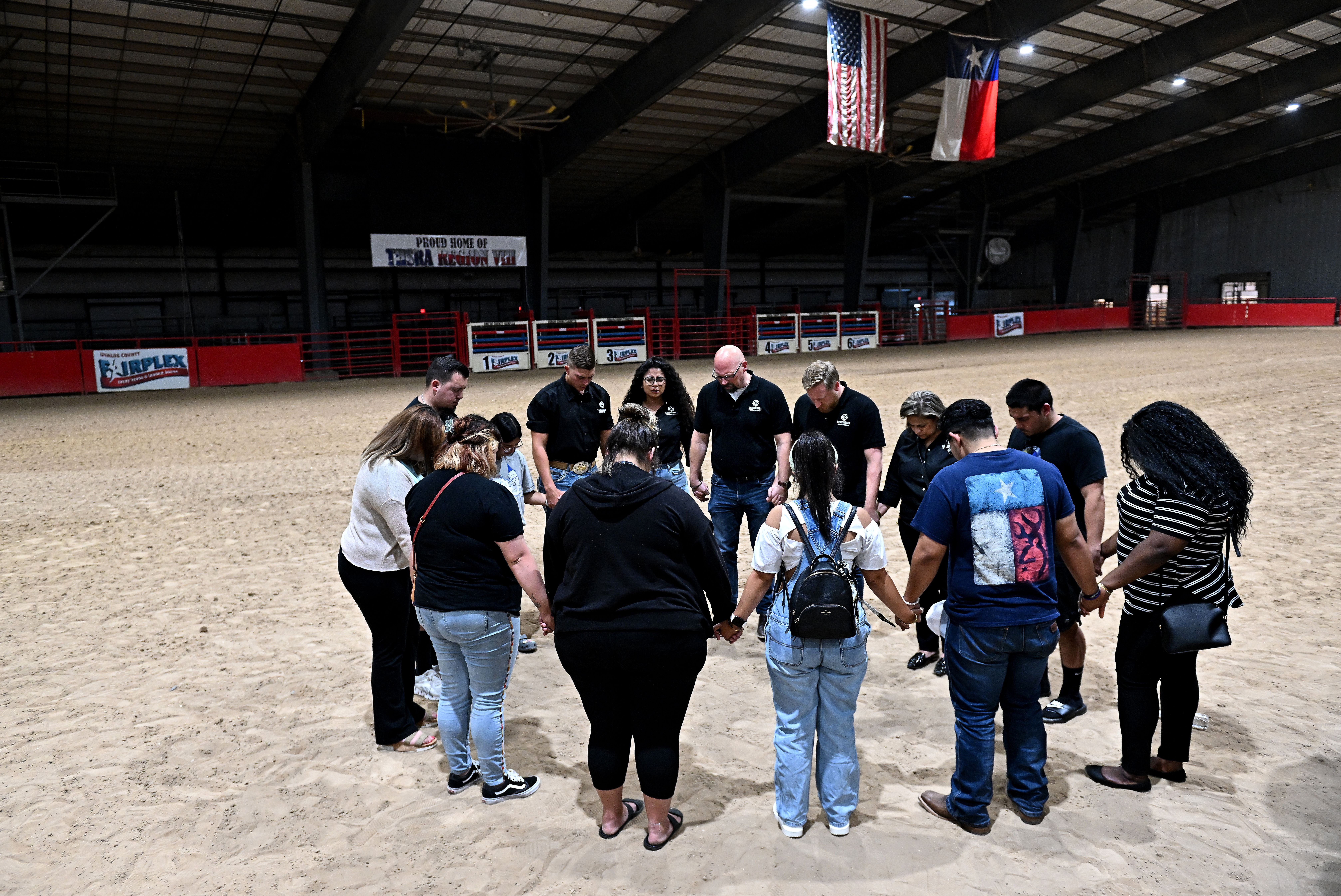  Mourners pray after a vigil Wednesday to honor the fallen victims of a mass shooting at the Uvalde County Fairplex in Texas Wednesday. 