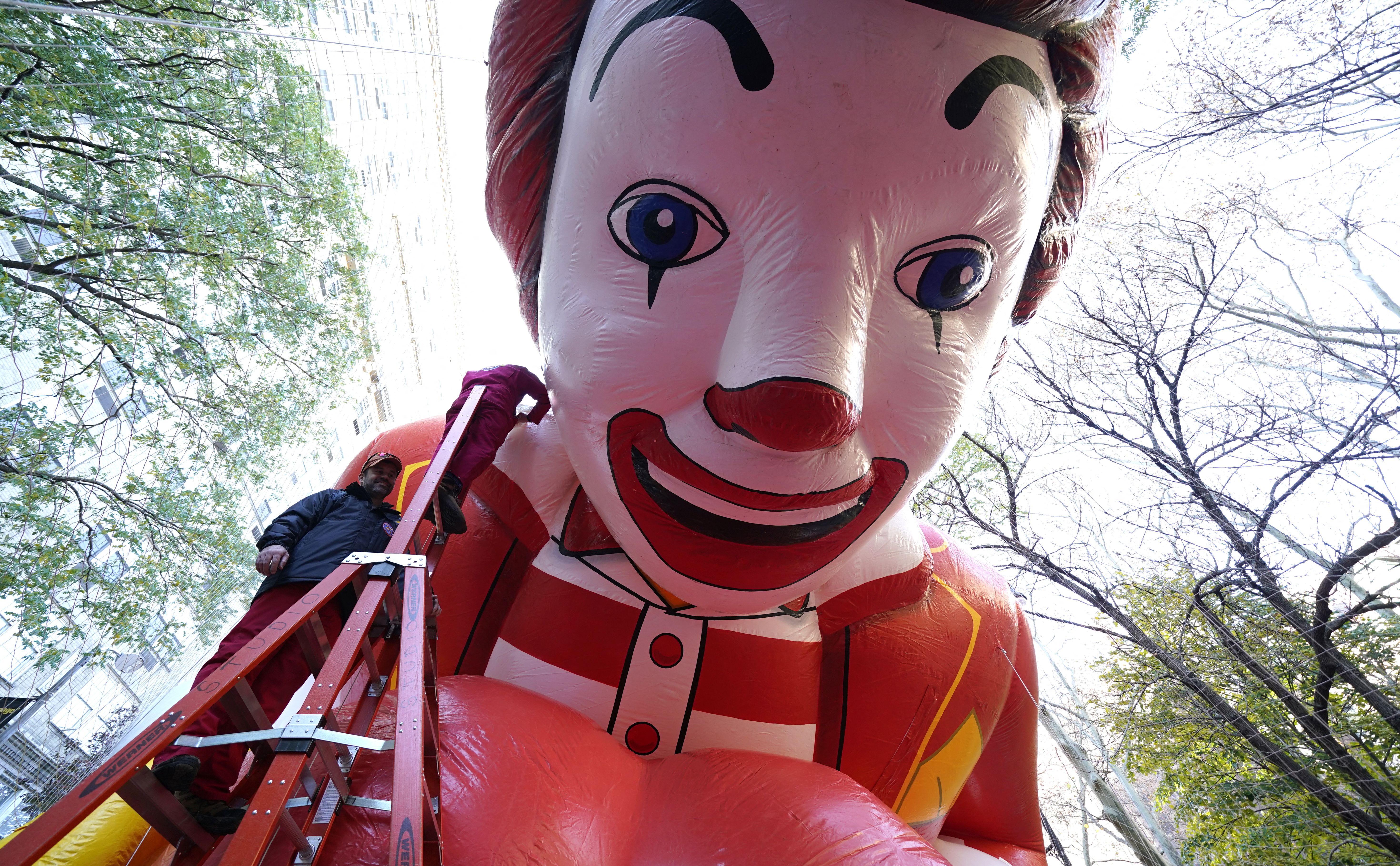 Workers prepare the Ronald McDonald balloon for today's parade.