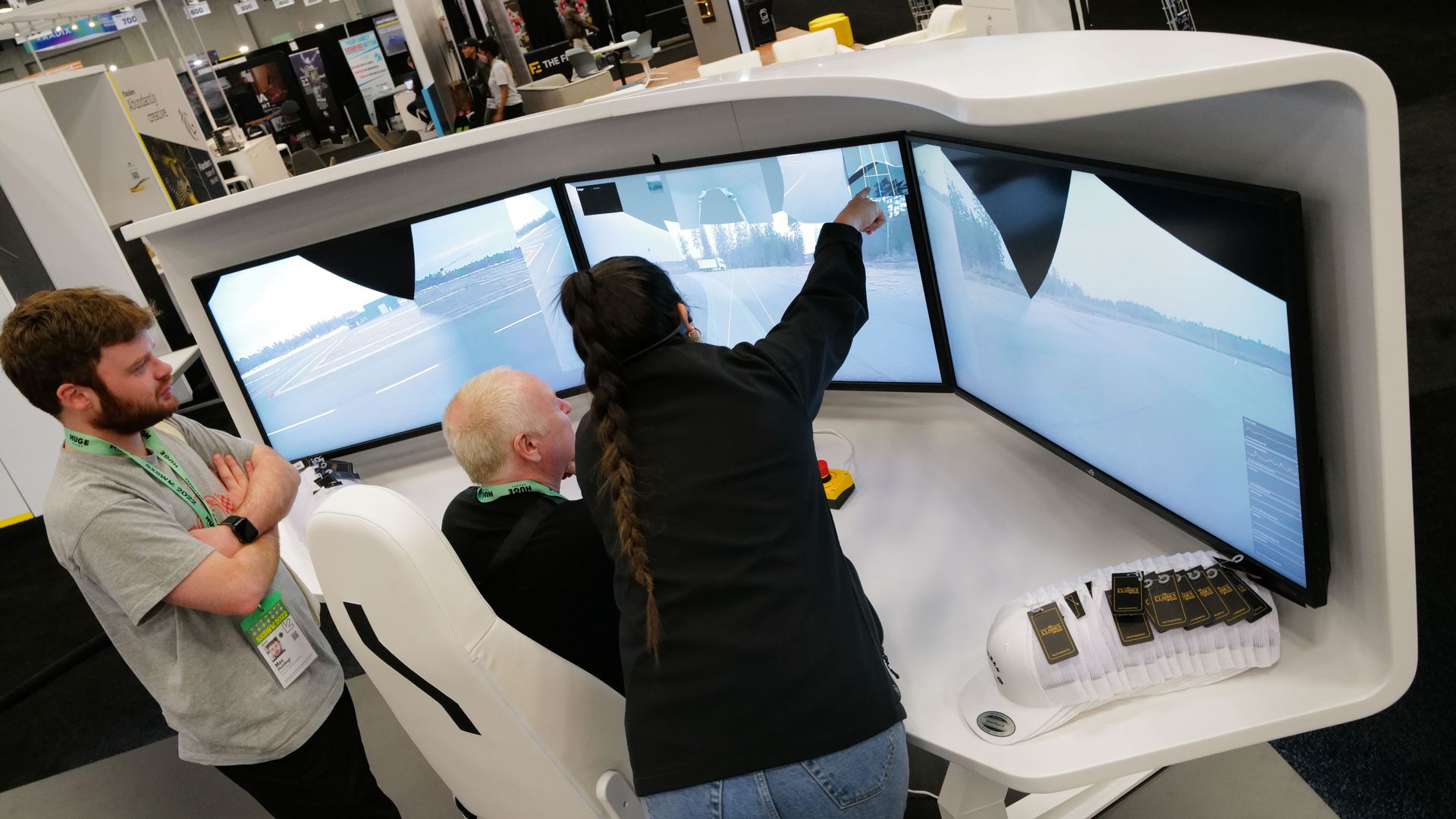 A three-screen demonstration of Einride's virtual driving system.