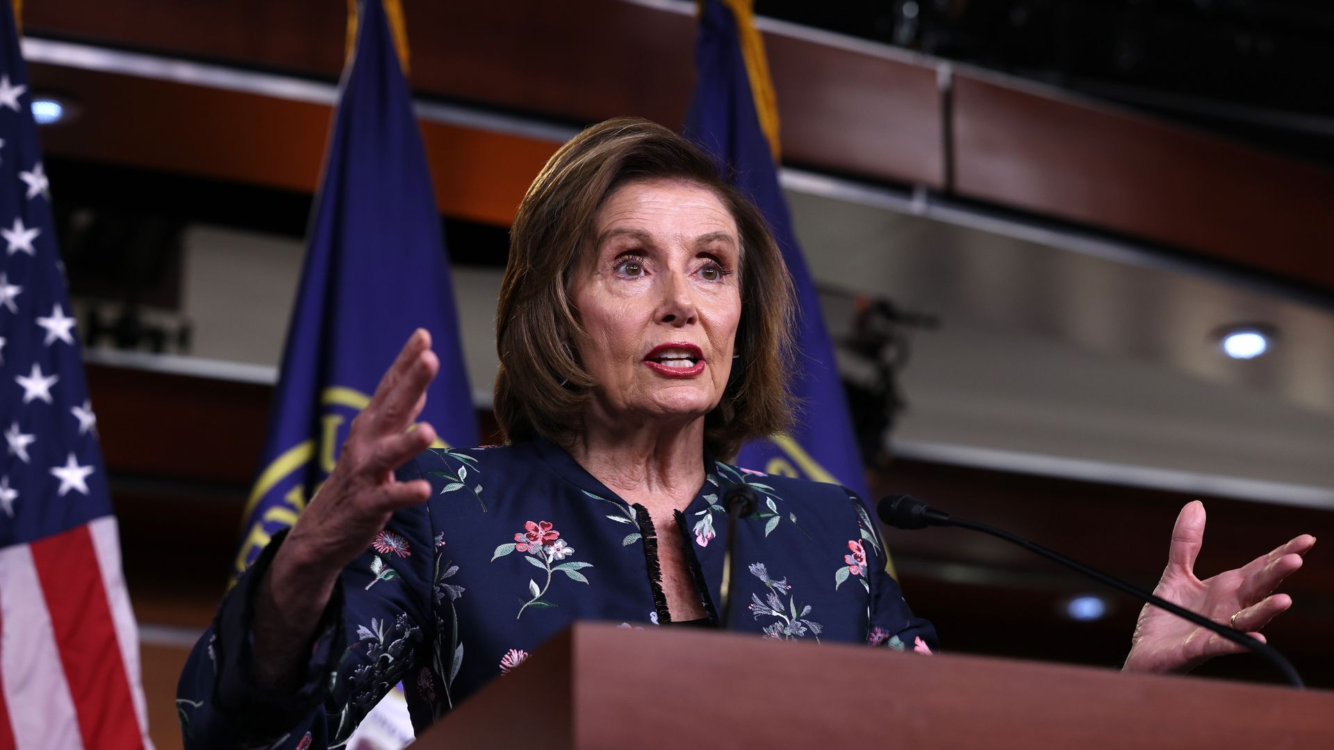 Pelosi stands at podium