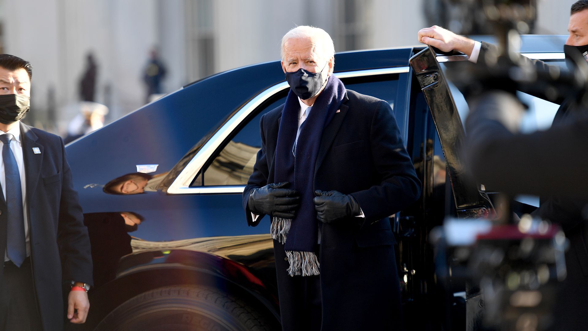 Photo of a masked Joe Biden emerging from a car
