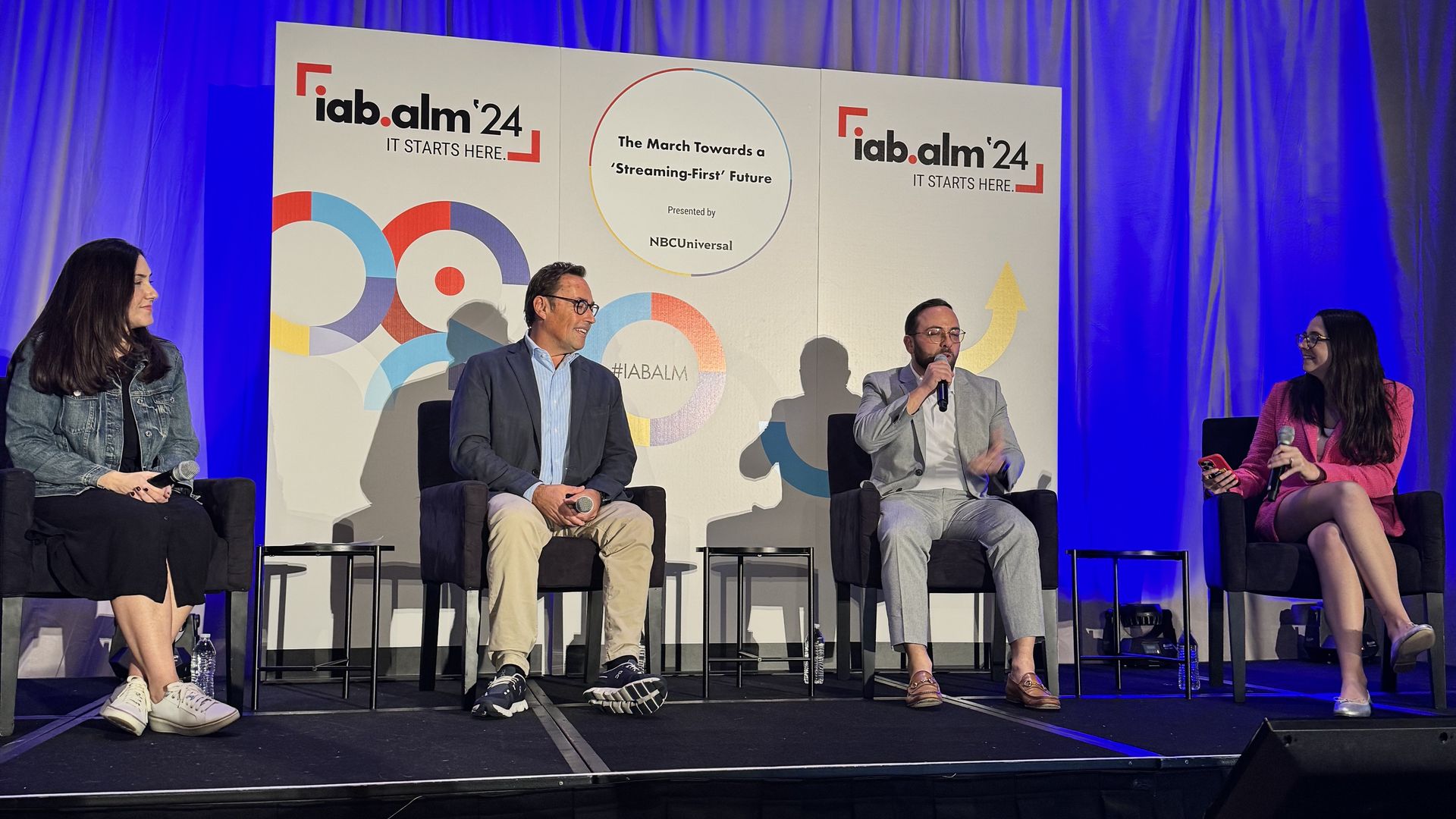 GroupM's Jessica Brown, NBCUniversal's Peter E. Blacker Unilever's Aaron Sobol and Axios' Kerry Flynn sitting on chairs on a stage with IAB ALM '24 in the background