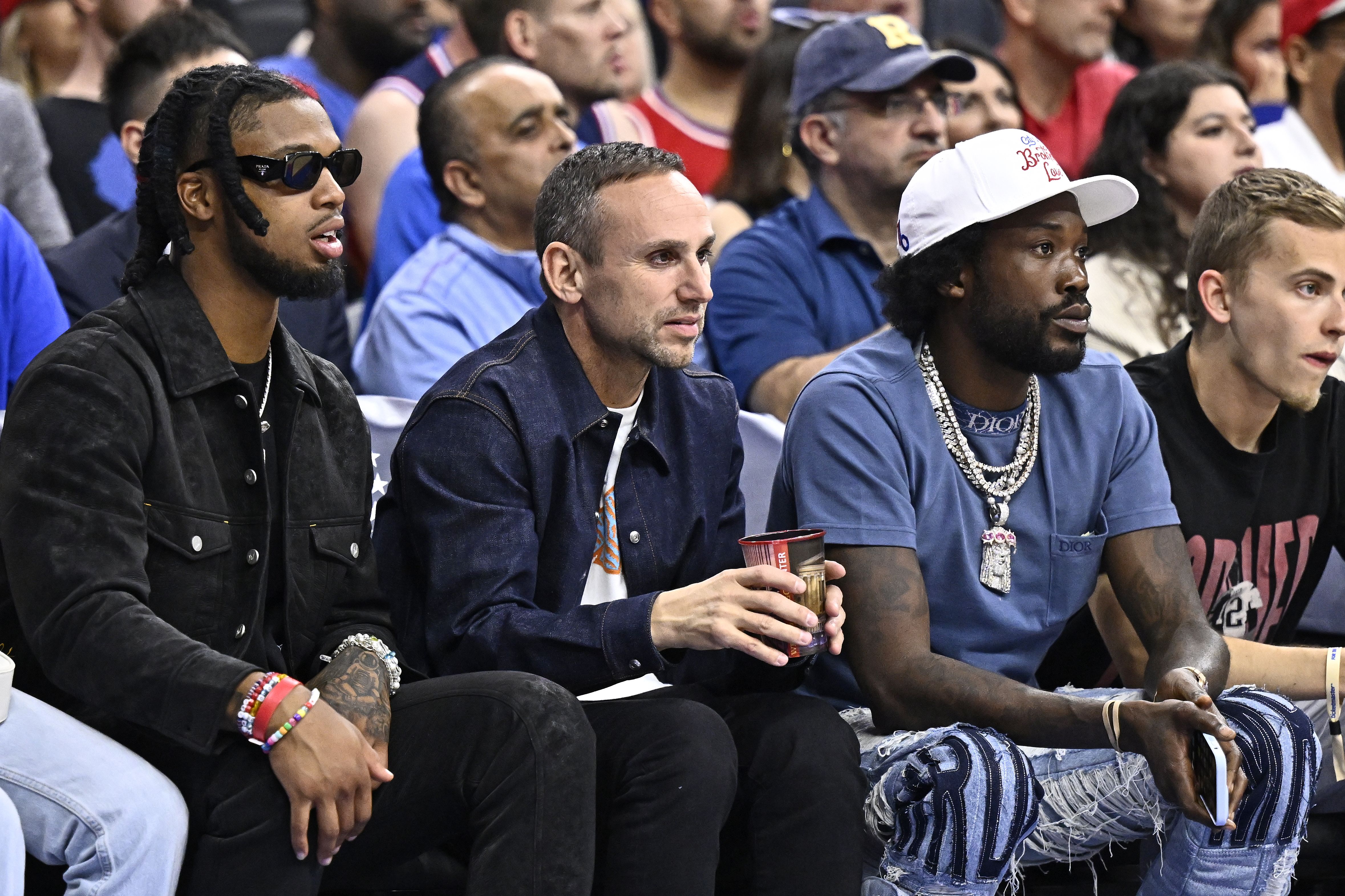 Michael Rubin, middle, and Meek Mill sitting court side during Game 6 of the Philadelphia 76ers second-round playoff matchup with the Boston Celtics.
