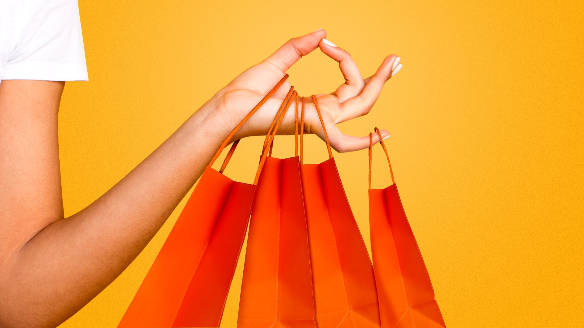 an illustration of a hand in a meditative pose holding four orange shopping bags