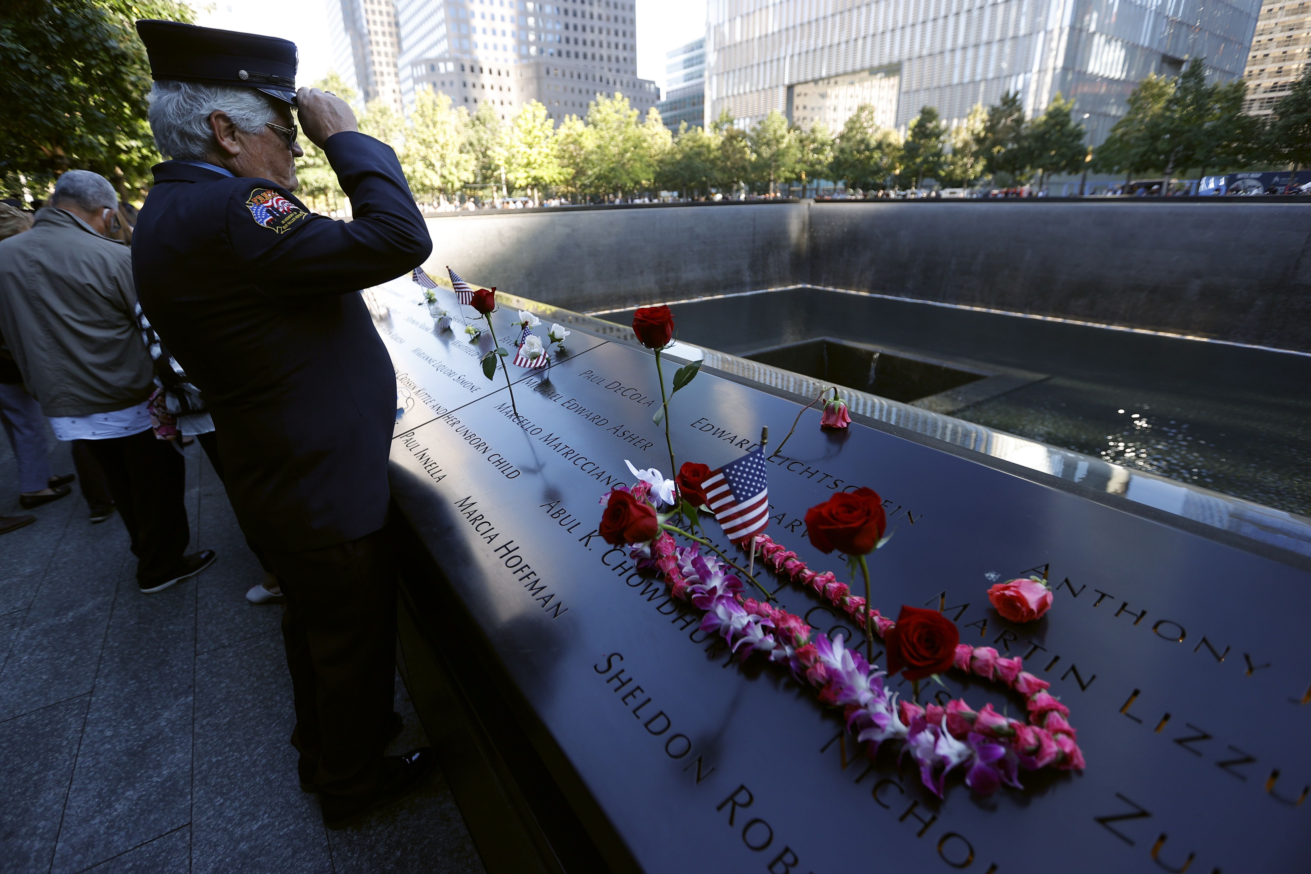 A member of the FDNY visits the reflecting pool. 