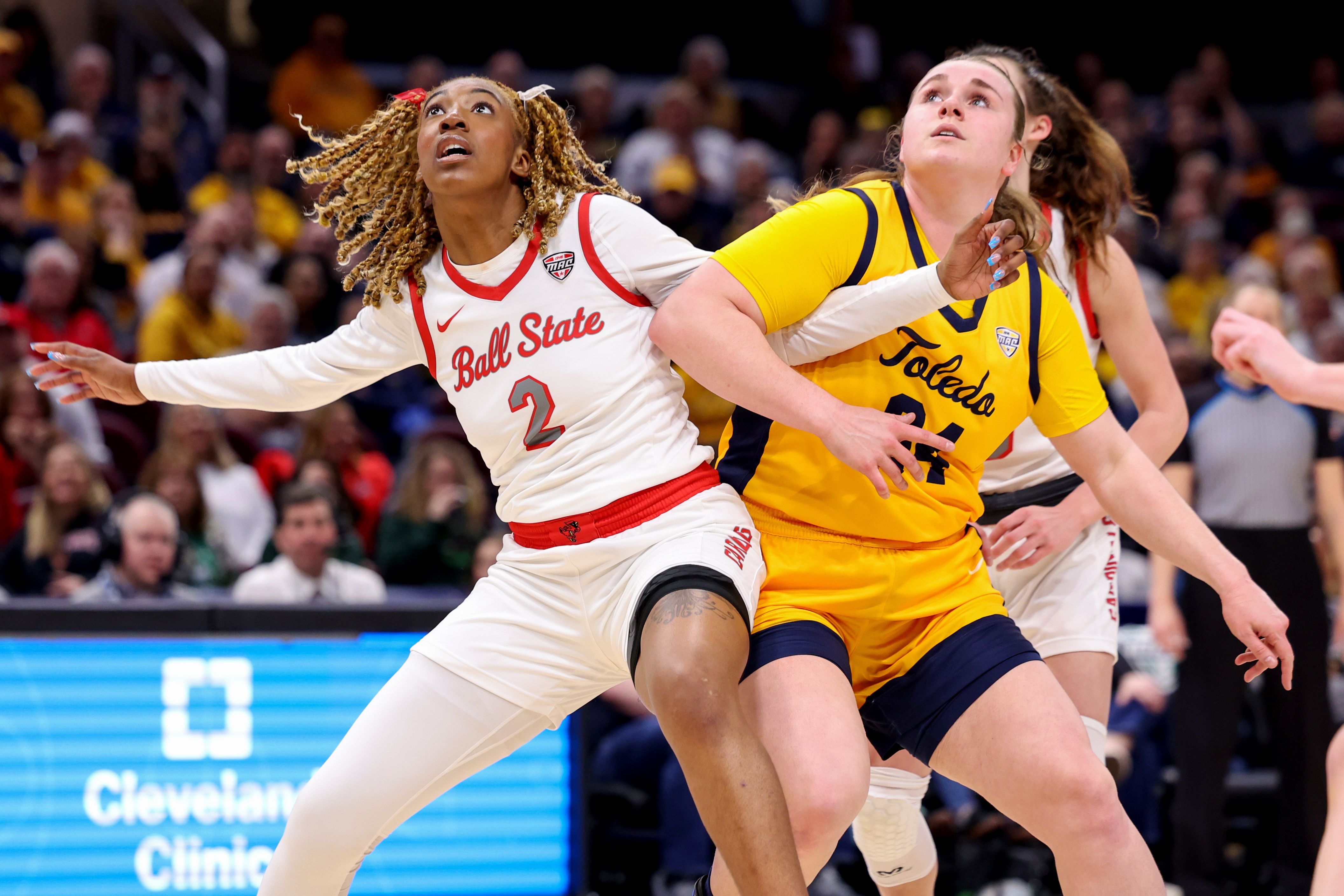Photo of two women fighting for a rebound during a basketball game.