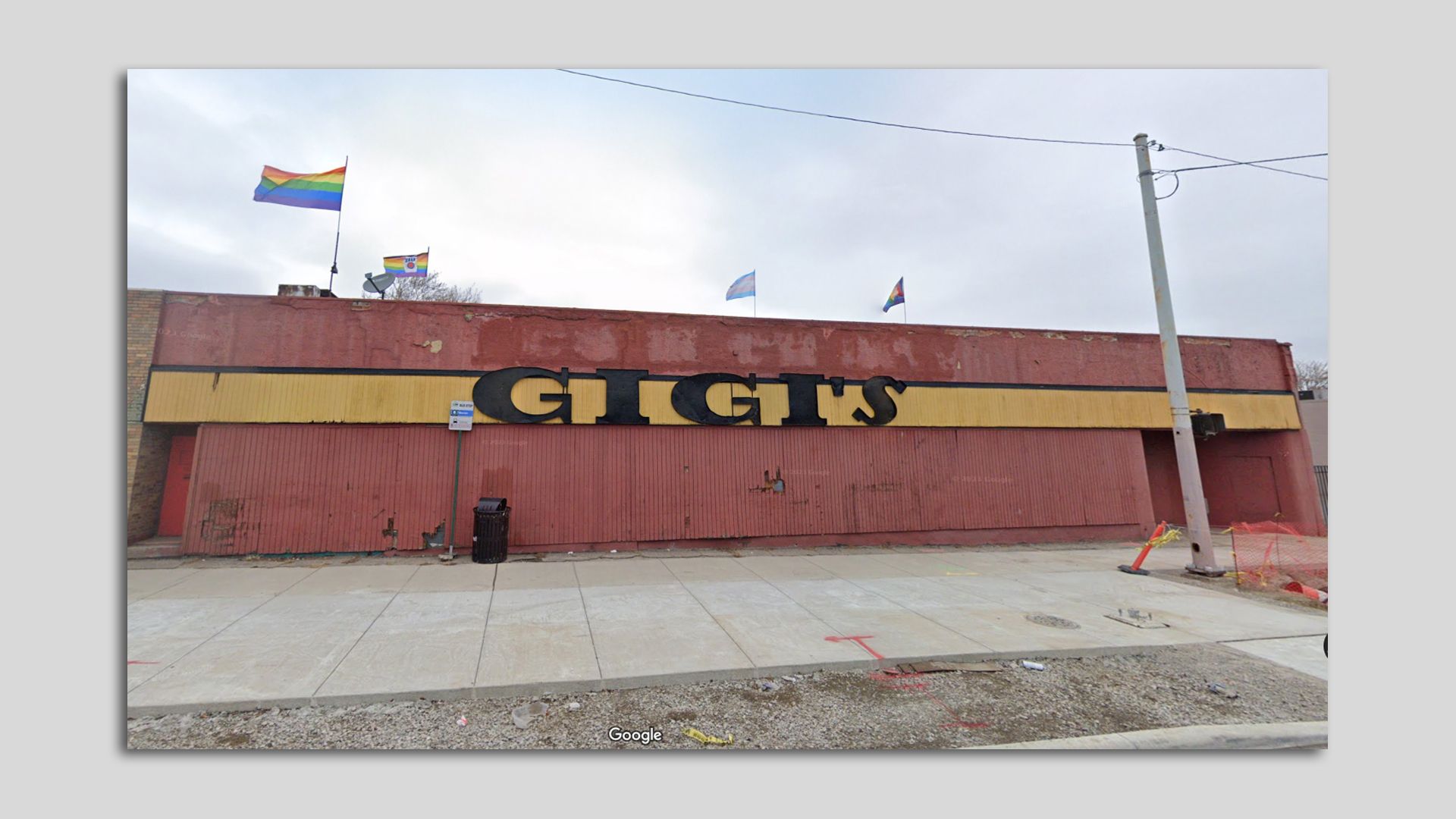 The Gigi's facade is shown with rainbow and trans flags flying above. 