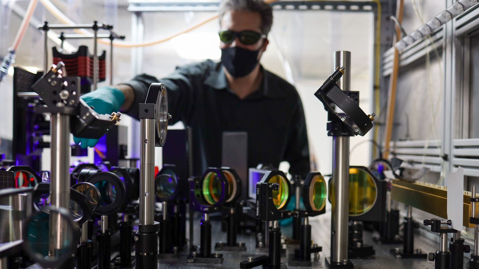 Chief Scientist Andy Bayramian makes modifications to the laser system on Seurat's 3D metal printer.