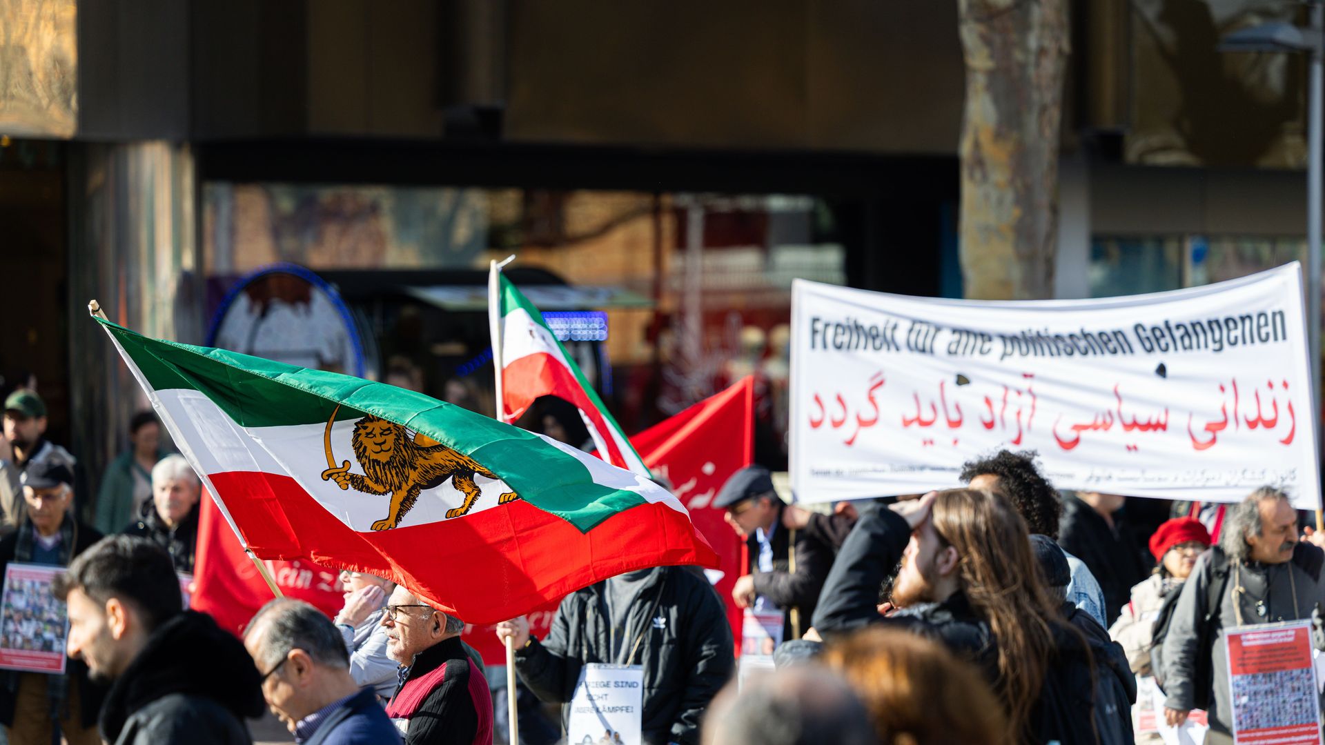 People weave flags in crowd