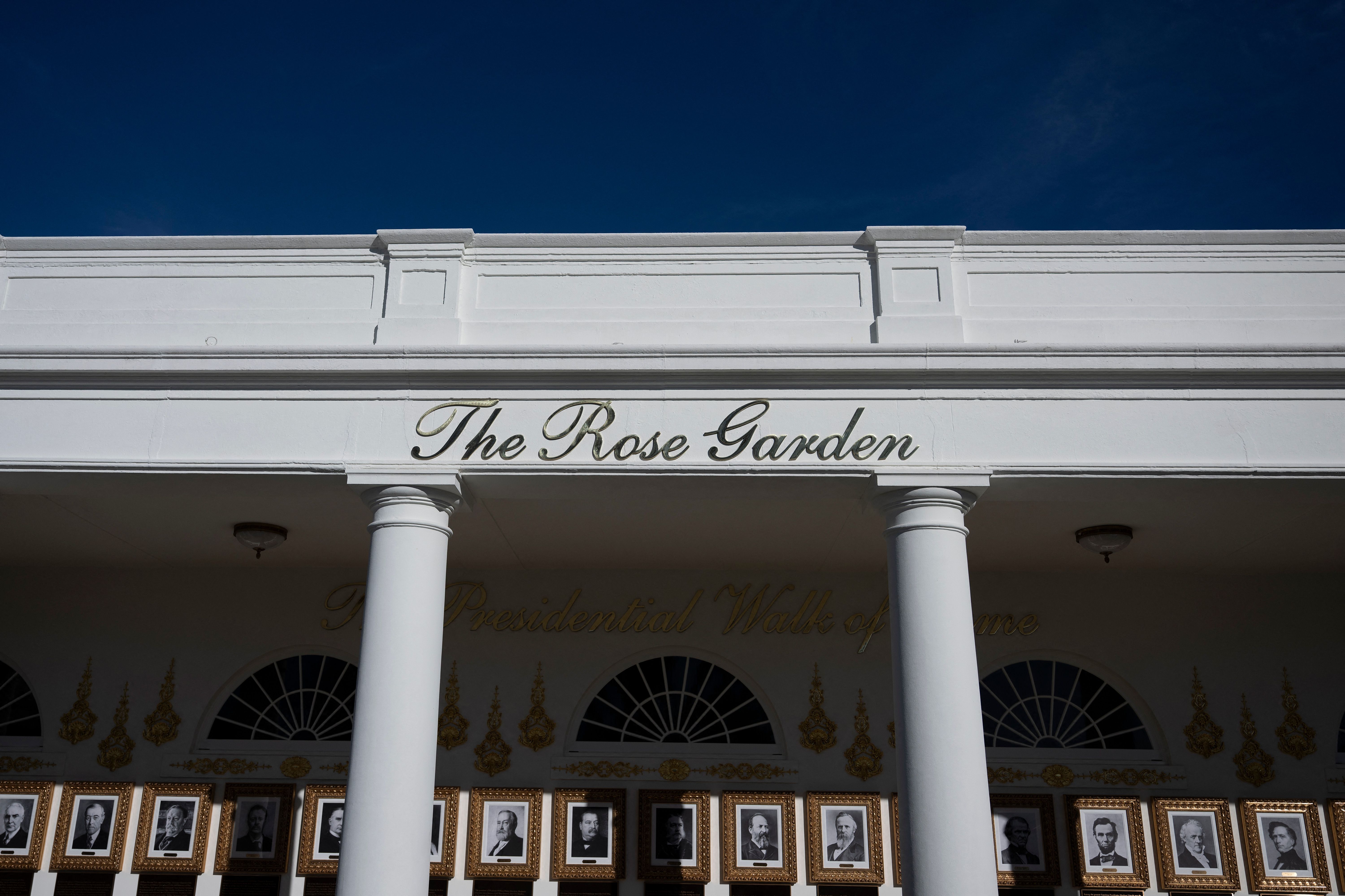 A sign reads "The Rose Garden," beneath which are framed black-and-white presidential portraits labeled "The Presidential Walk of Fame."