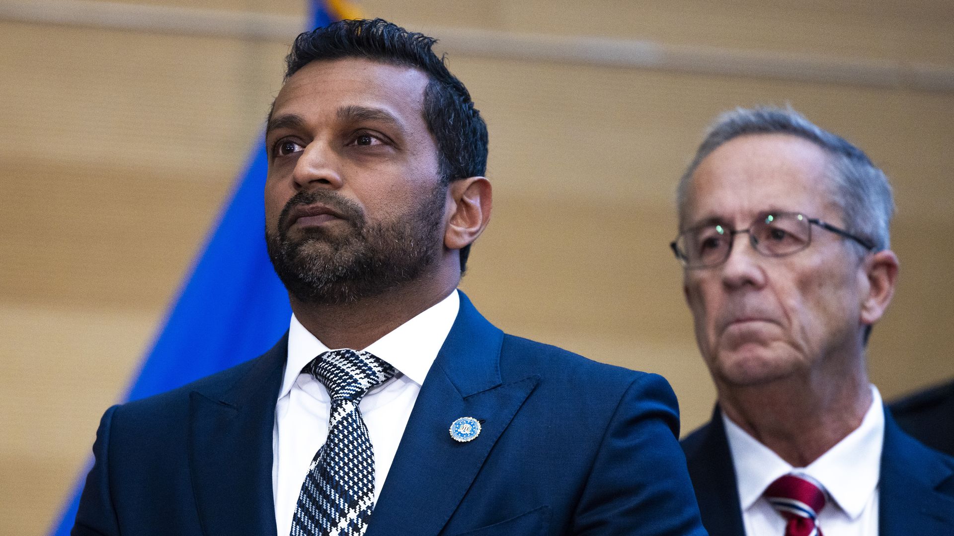 Kash Patel listens at a press conference about Charlie Kirk's assassination.