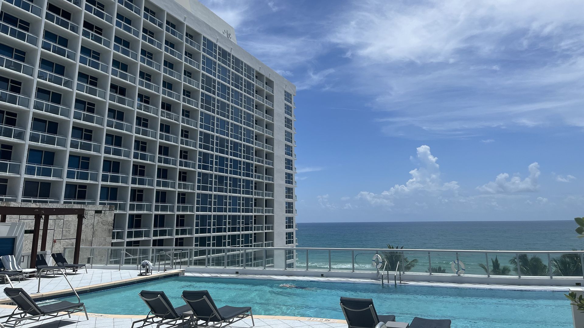 The rooftop pool at the Carillon Miami Wellness Resort is pictured with the Atlantic Ocean in the distance.