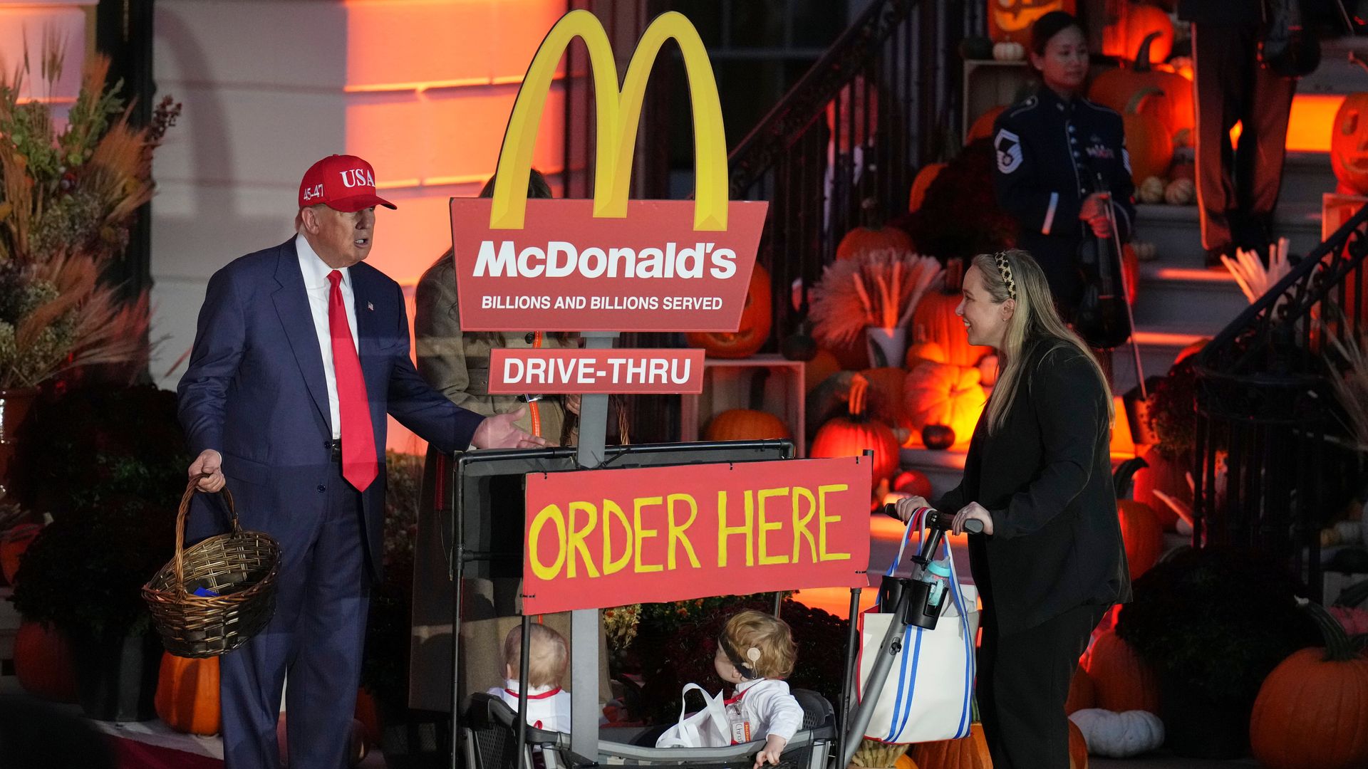  President Donald Trump, from left, hands out candy and greet a family dressed as employees of a McDonald's Drive-Thur during a Halloween event on the South Lawn of the White House, Thursday, Oct. 30, 2025, in Washington. (AP Photo/Jacquelyn Martin)