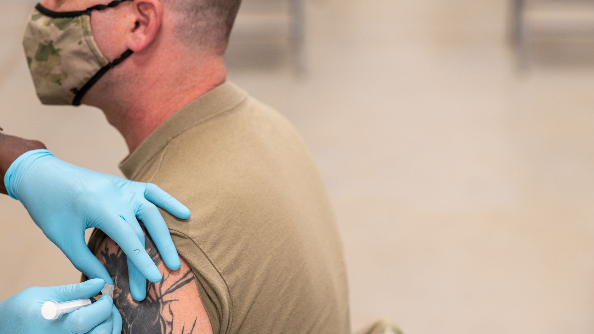 A soldier receives the vaccine
