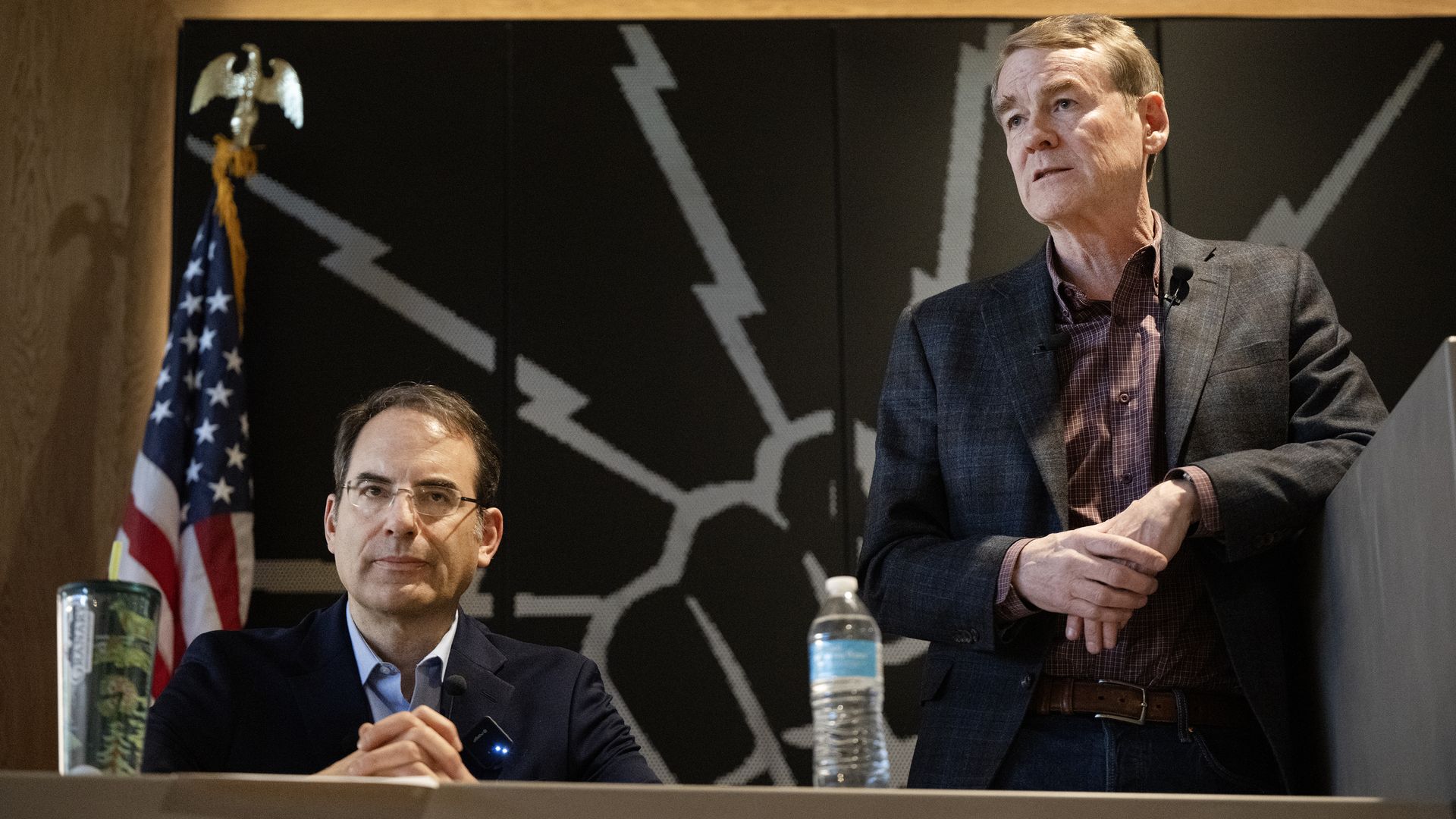 Michael Bennet, right, answers a question as fellow candidate Attorney General Phil Weiser looks into the audience a January campaign forum. Photo: Timothy Hurst/Denver Post via Getty Images