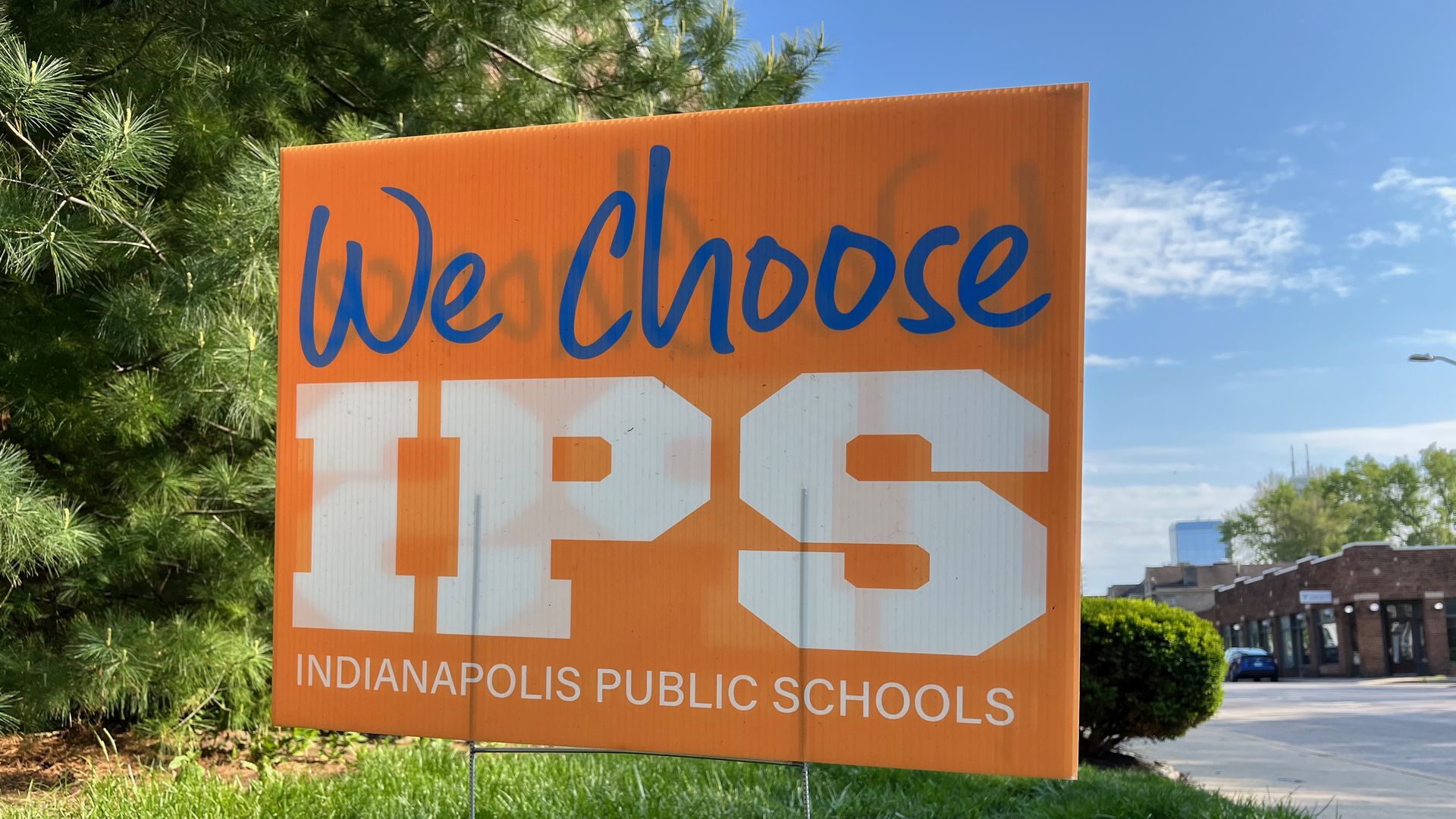 An orange sign reads: We choose IPS