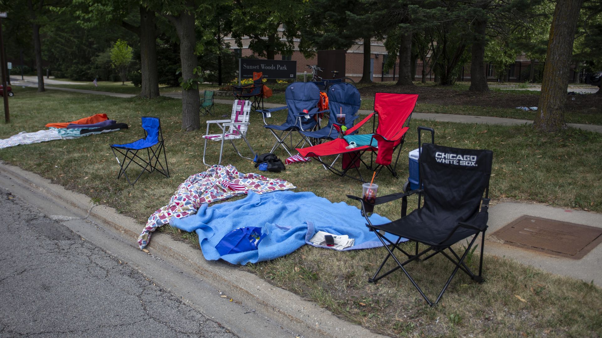 Chairs and blankets are left abandoned after a shooting at a Fourth of July parade on July 4, 2022 in Highland Park, Illinois.