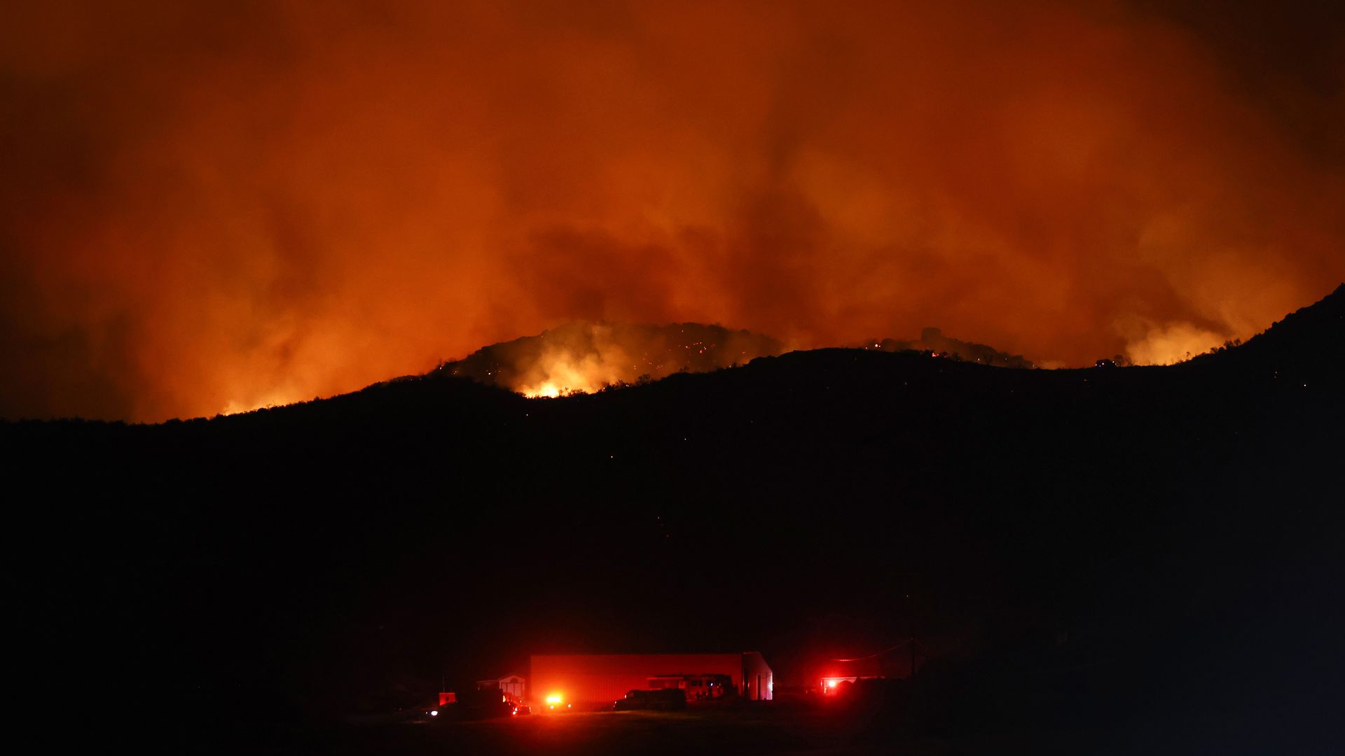 The Fairview Fire burns above a structure on September 5, 2022 near Hemet, California. 