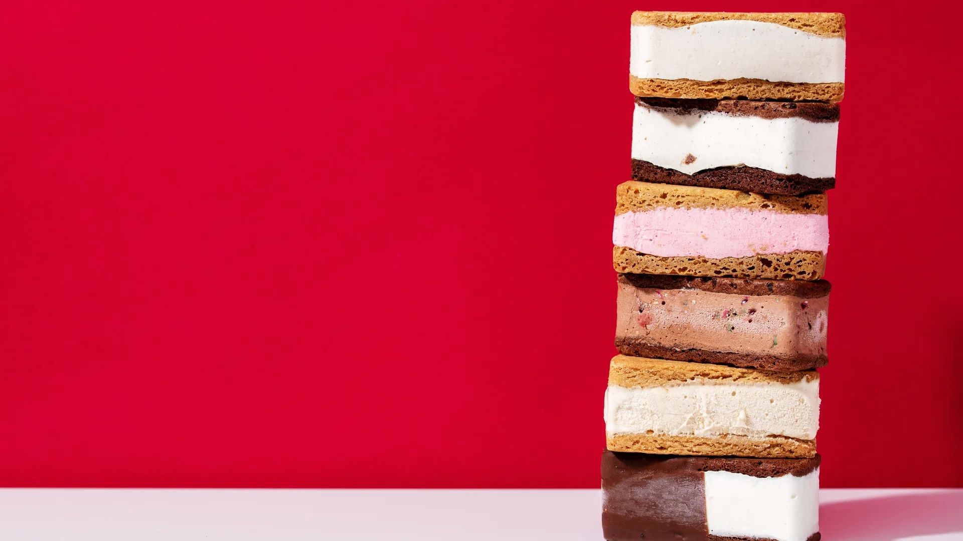 ice cream sandwiches stacked on top of each other in front of a red background