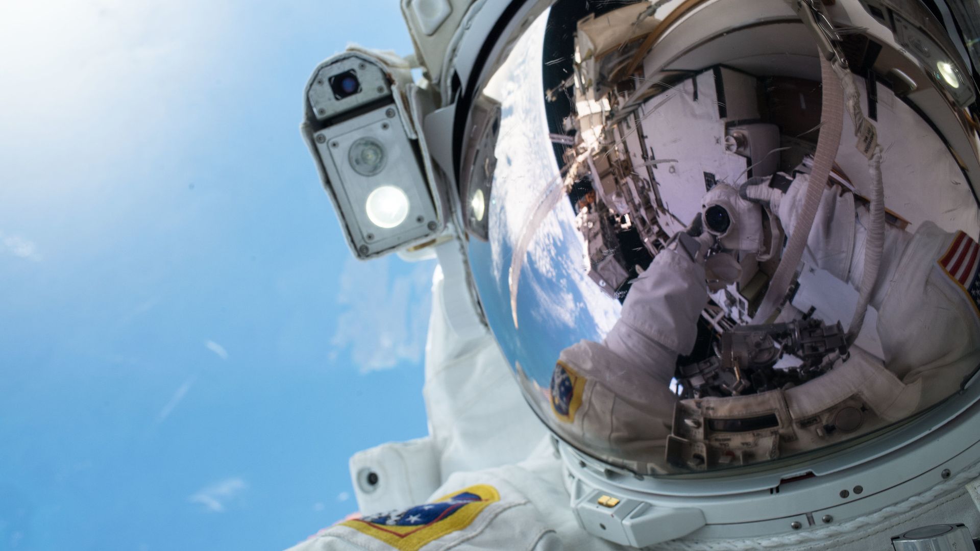 An astronaut selfie in space with Earth in the background