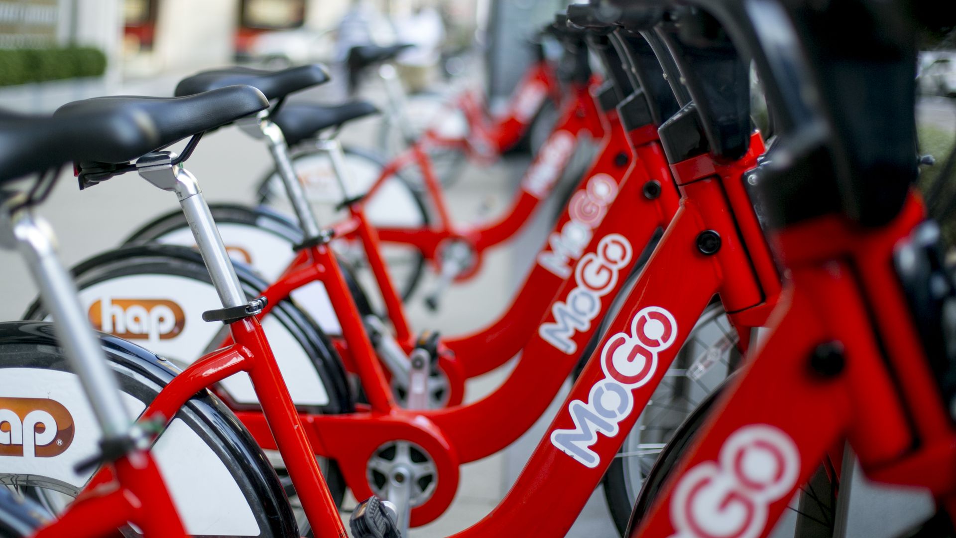 The red bikes docked together, with the red and gray MoGo logo on the side of each bike