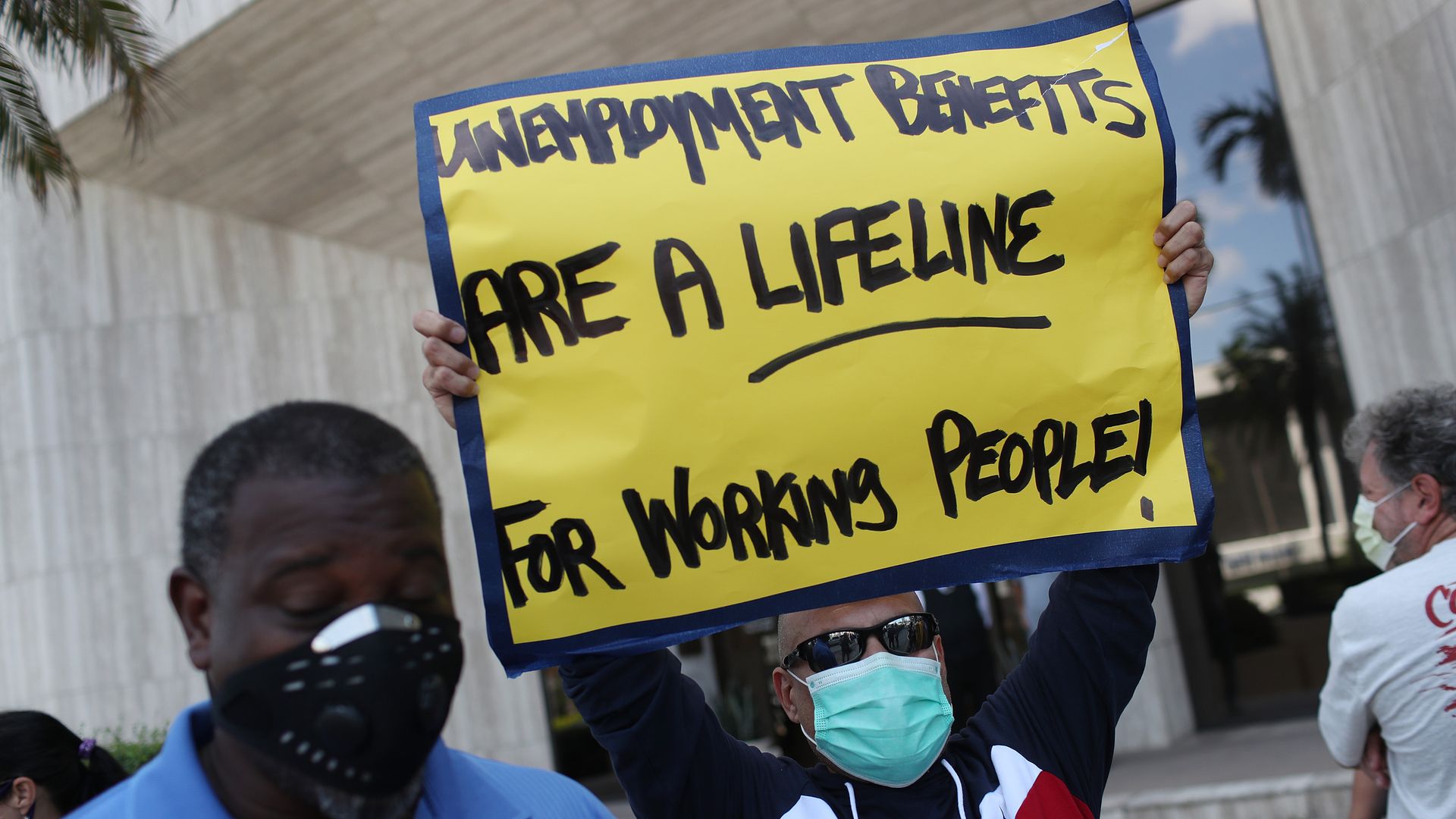 arlos Ponce joins other demonstrators participating in a protest asking Senators to support the continuation of unemployment benefits on July 16, 2020 in Miami Springs, Florida.