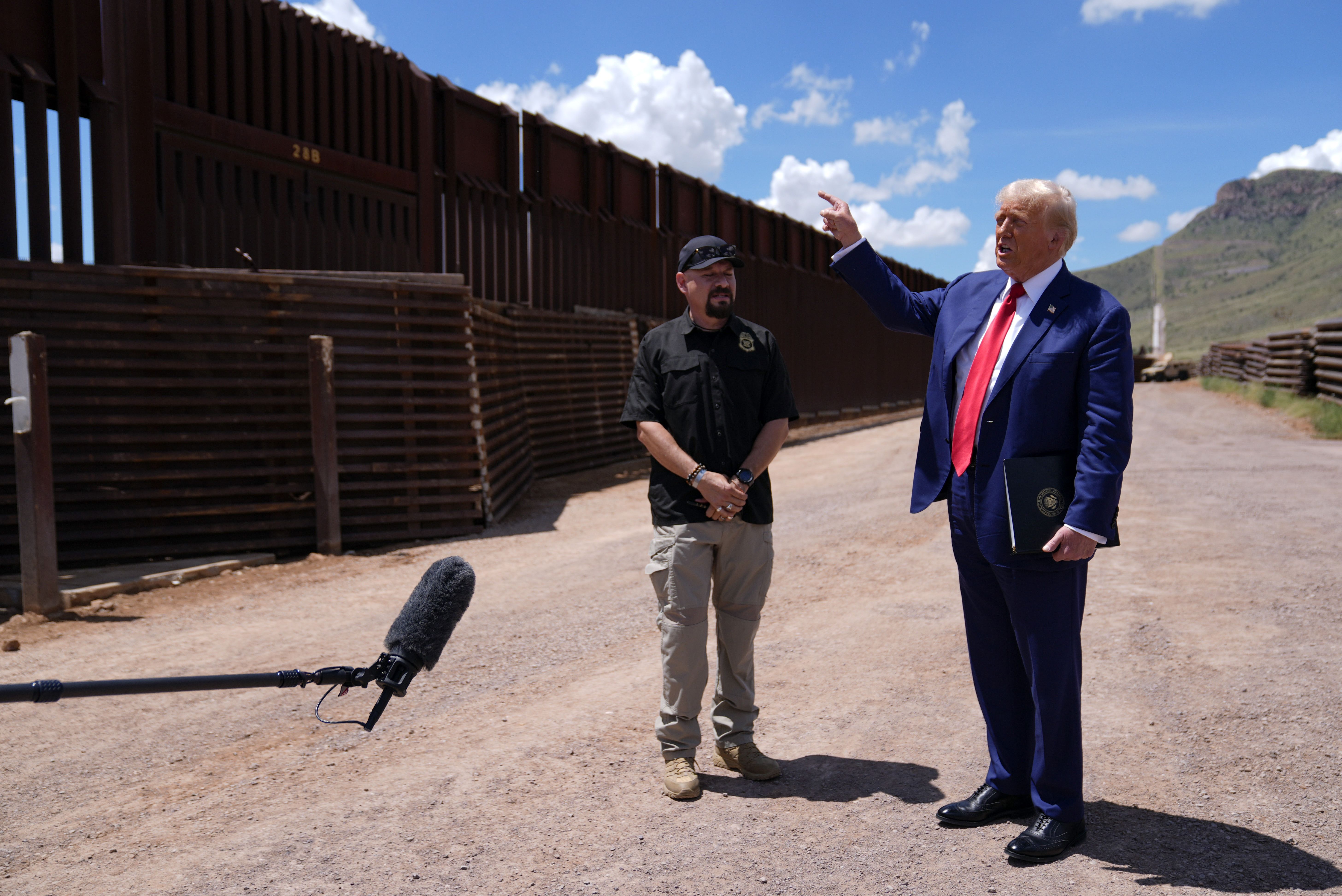 Republican presidential nominee former President Donald Trump talks with Paul Perez, president of the National Border Patrol Council, as he tours the southern border with Mexico