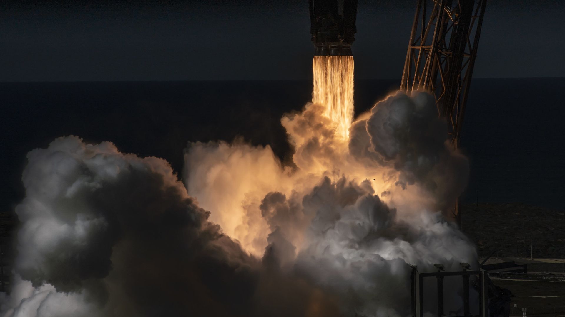 A close-up of a rocket launching to space