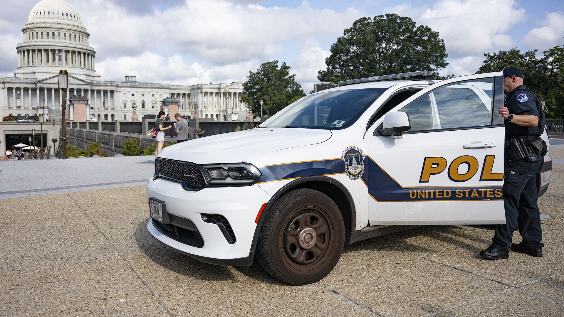 An US Capitol Police office enters his car parked on the side walk near the US Capitol in Washington, DC, on August 8, 2025. US President Donald Trump ordered on August 7 to use federal law enforcement in Washington, DC to combat crime. (Photo by Jim WATSON / AFP)