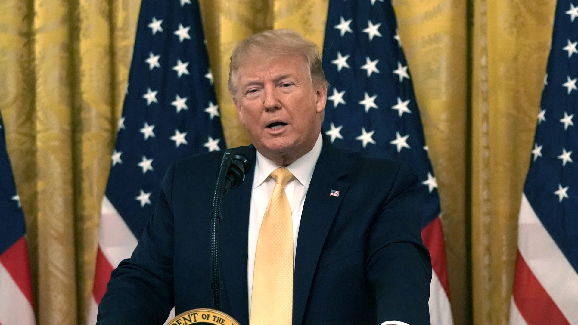 Trump standing at a podium. 