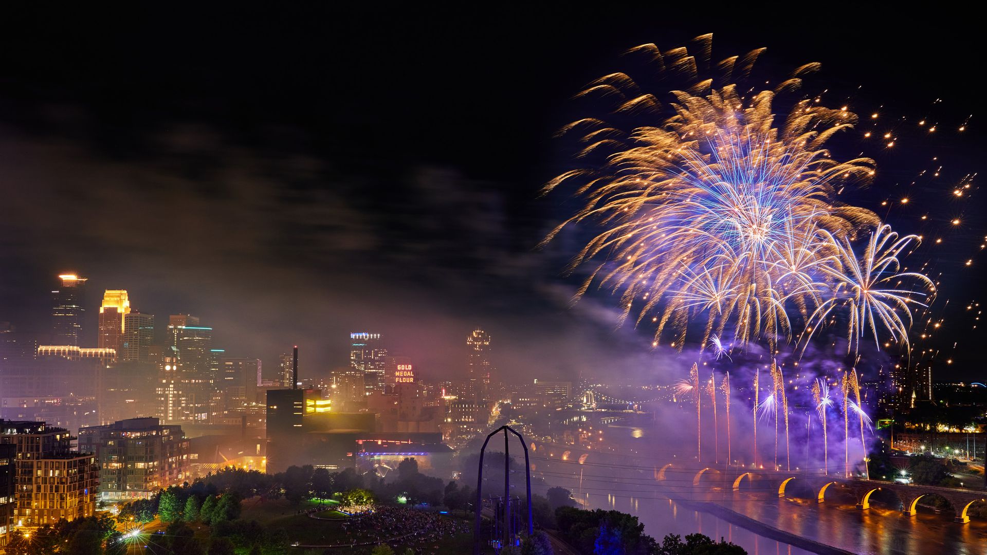 Fireworks over the Mississippi River with views of downtown Minneapolis skyline in the backdrop. 