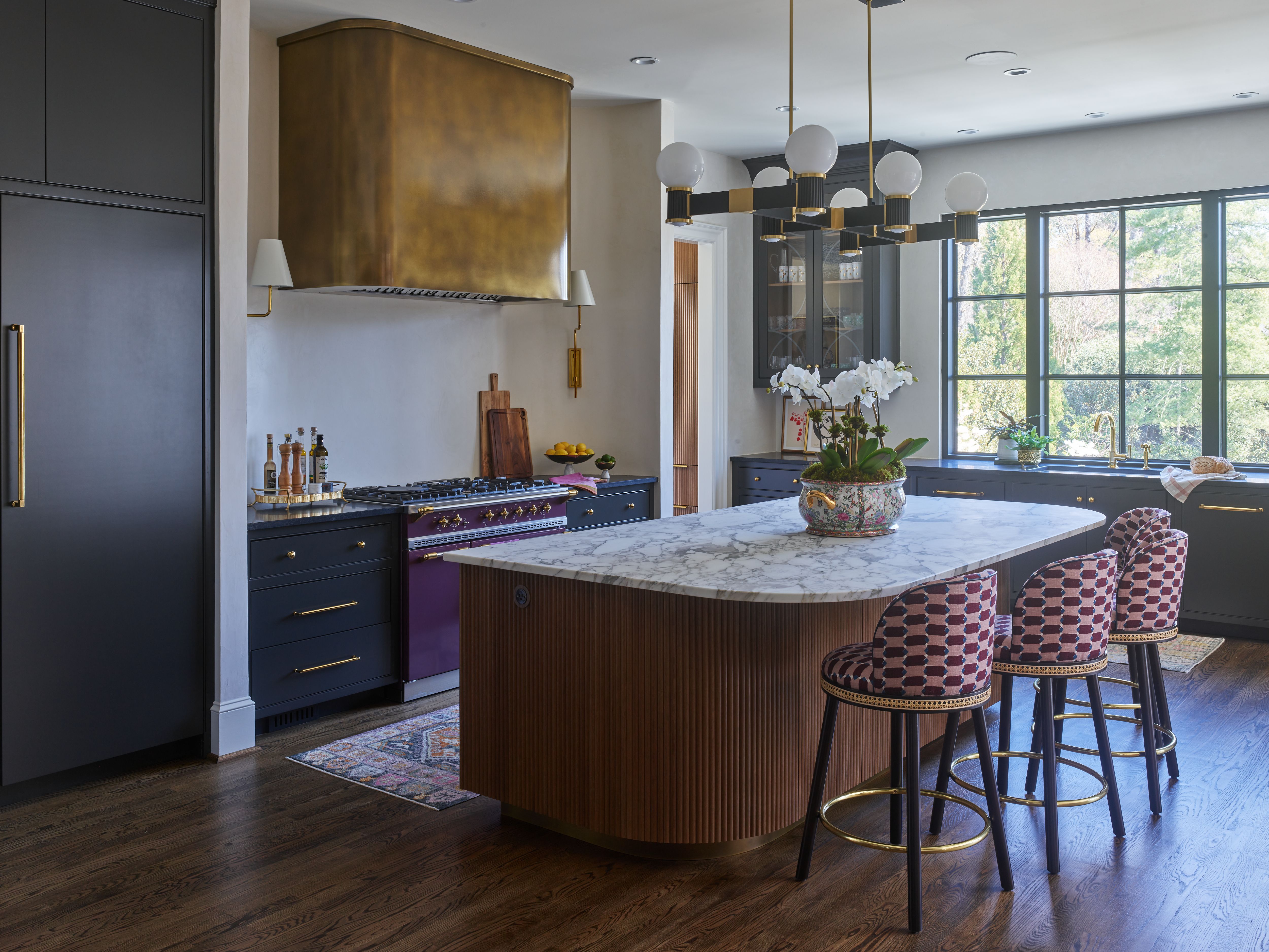 kitchen with a gold range hood and a purple range