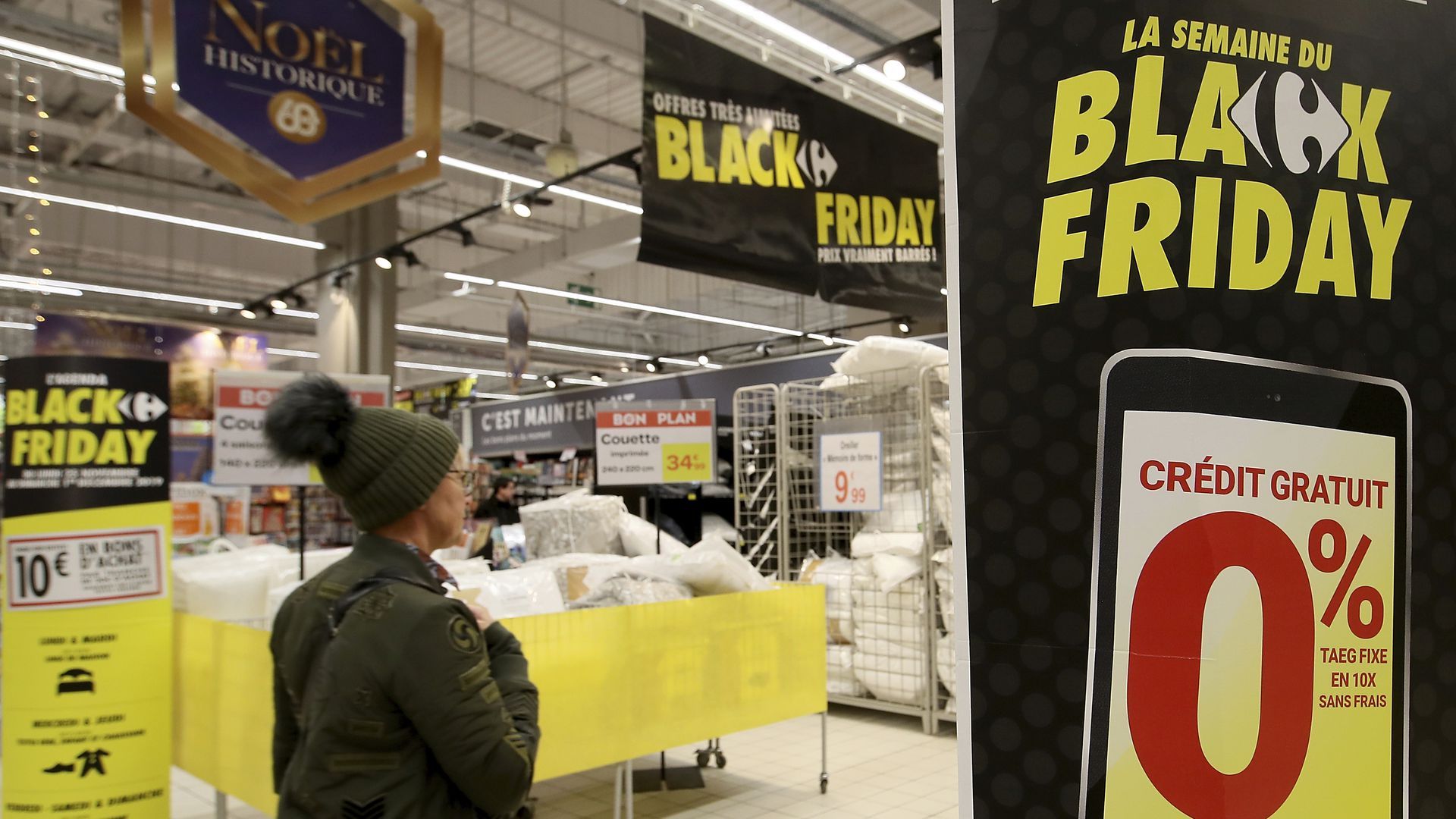 In this image, a woman walks into a store