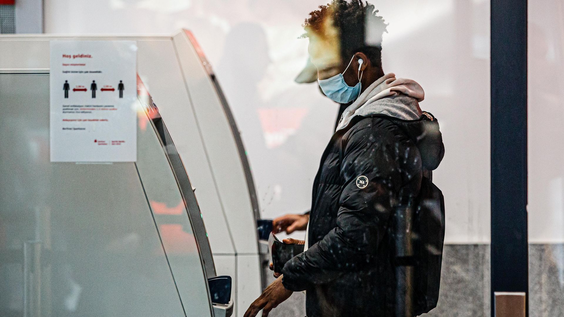 Photo of a man using a bank ATM