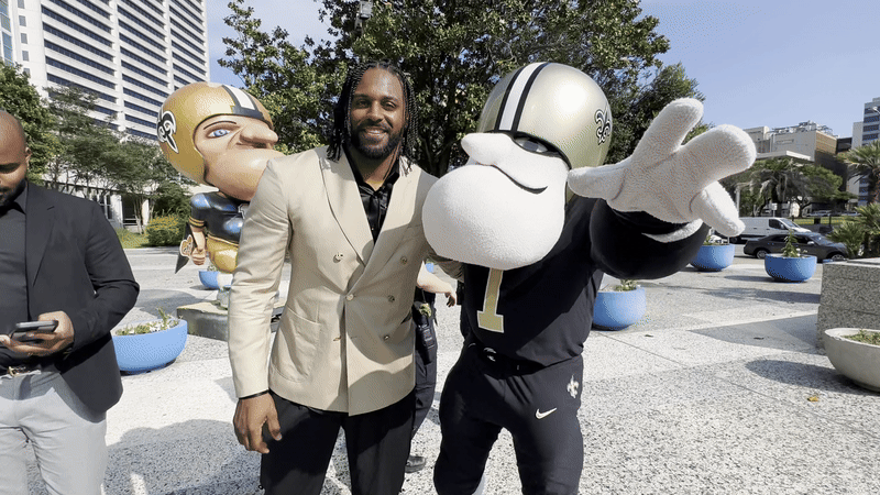 Image shows Cam Jordan with Sir Saint.