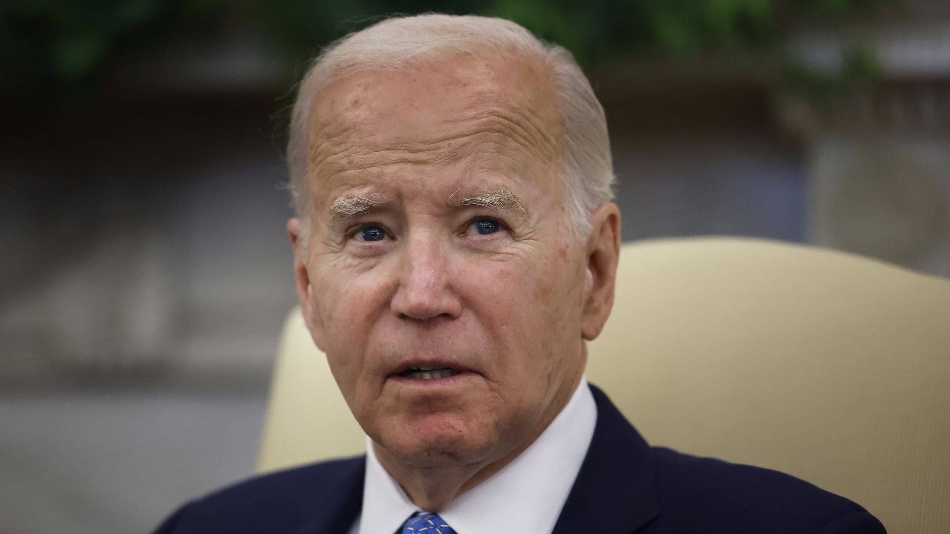 President Joe Biden, wearing a dark blue suit, white shirt and light blue tie.
