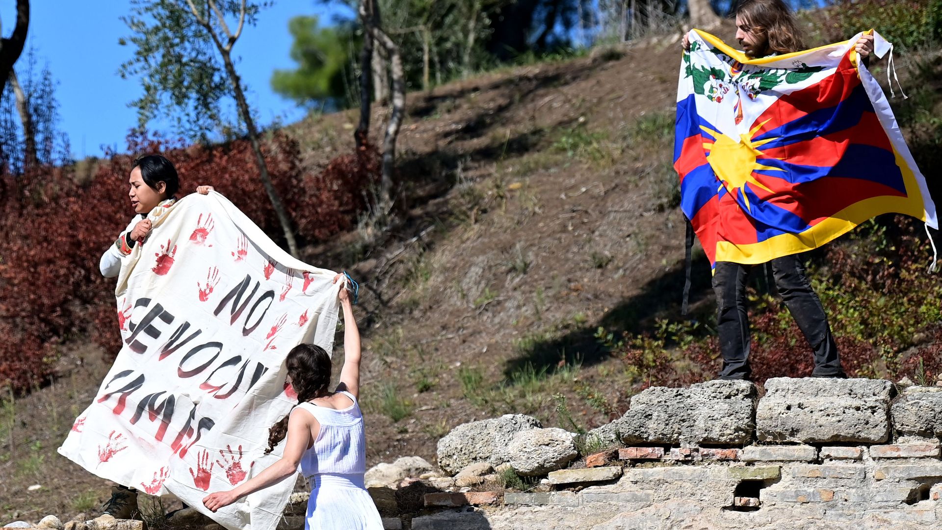 Protestors at the Beijing Winter Olympics flame lighting ceremony