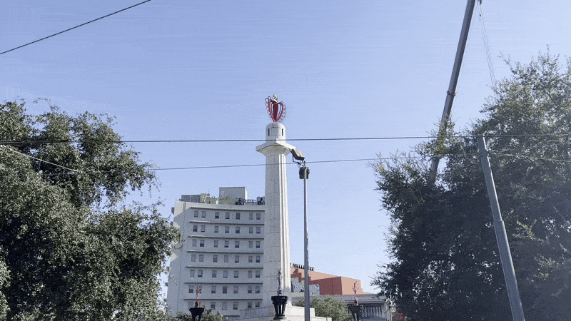 A video zooms in on a heart-shaped sculpture atop a column.