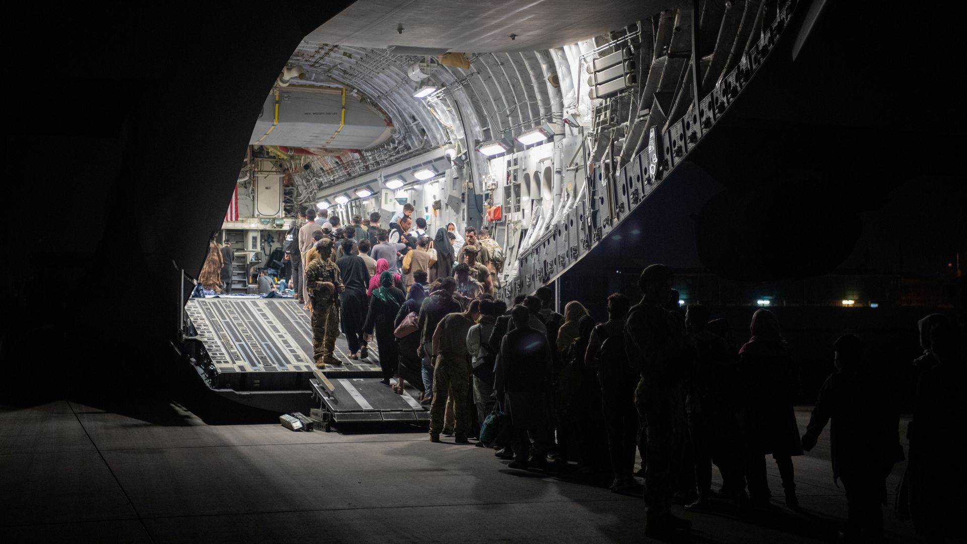 Afghans board a U.S. C-17 in Kabul