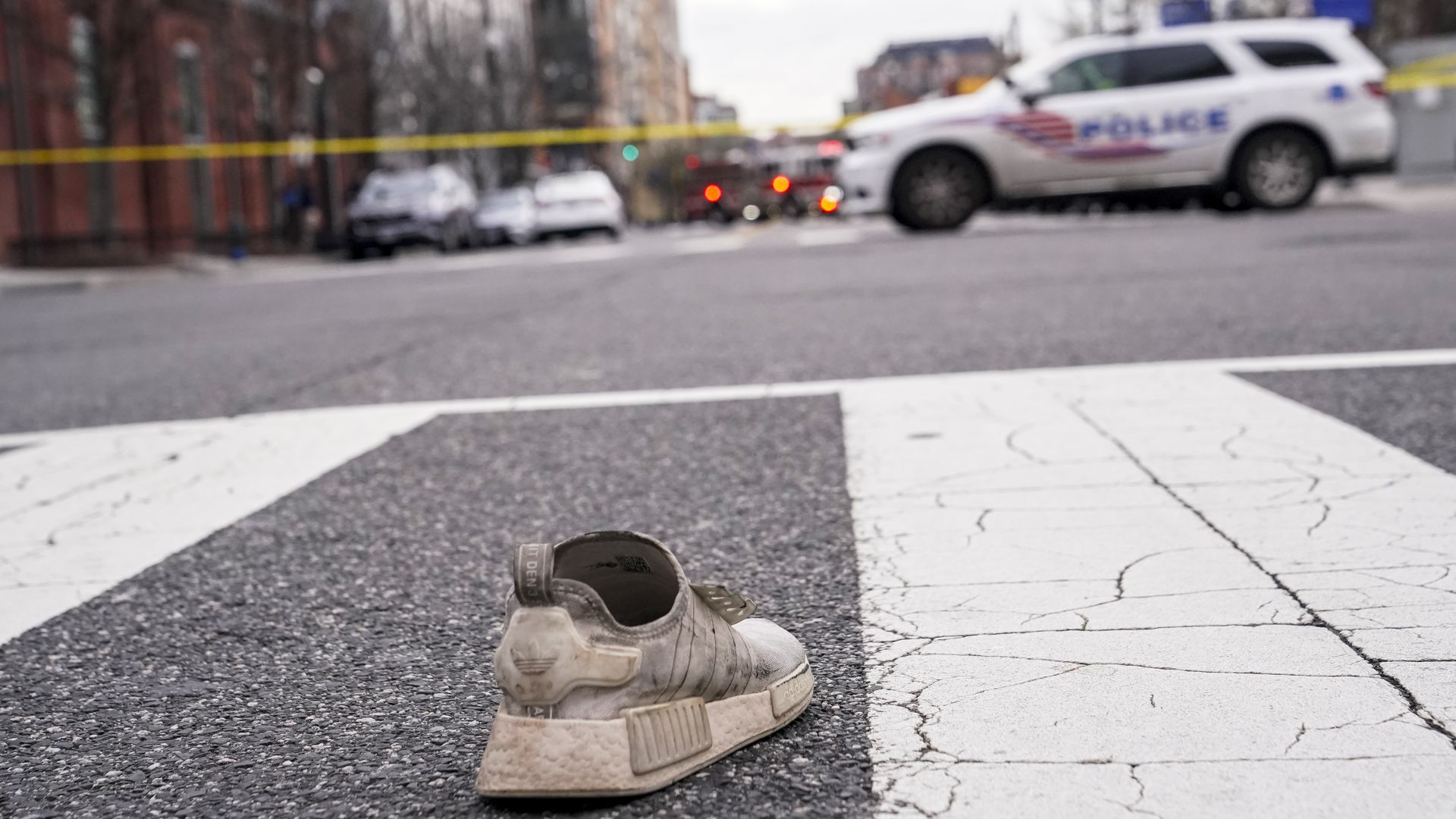 An abandoned shoe is seen in the street at the site of an early morning shooting in the Shaw neighbourhood on March 17, 2024 in Washington, D.C.