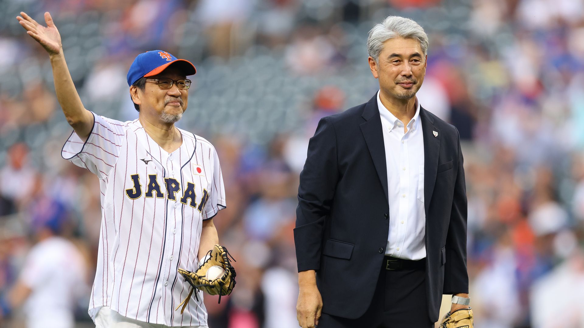 men waving at baseball game