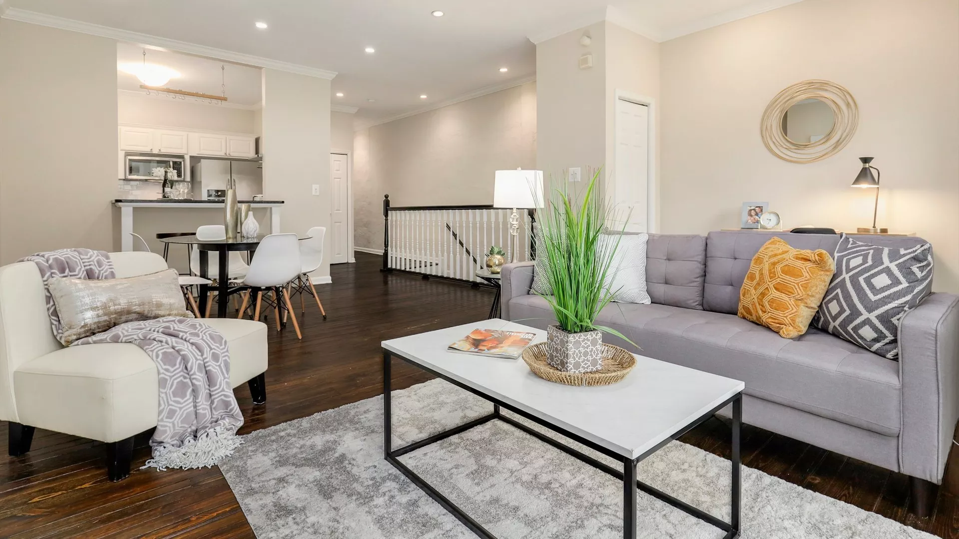 A couch with a nice chair and a coffee table in a living room.