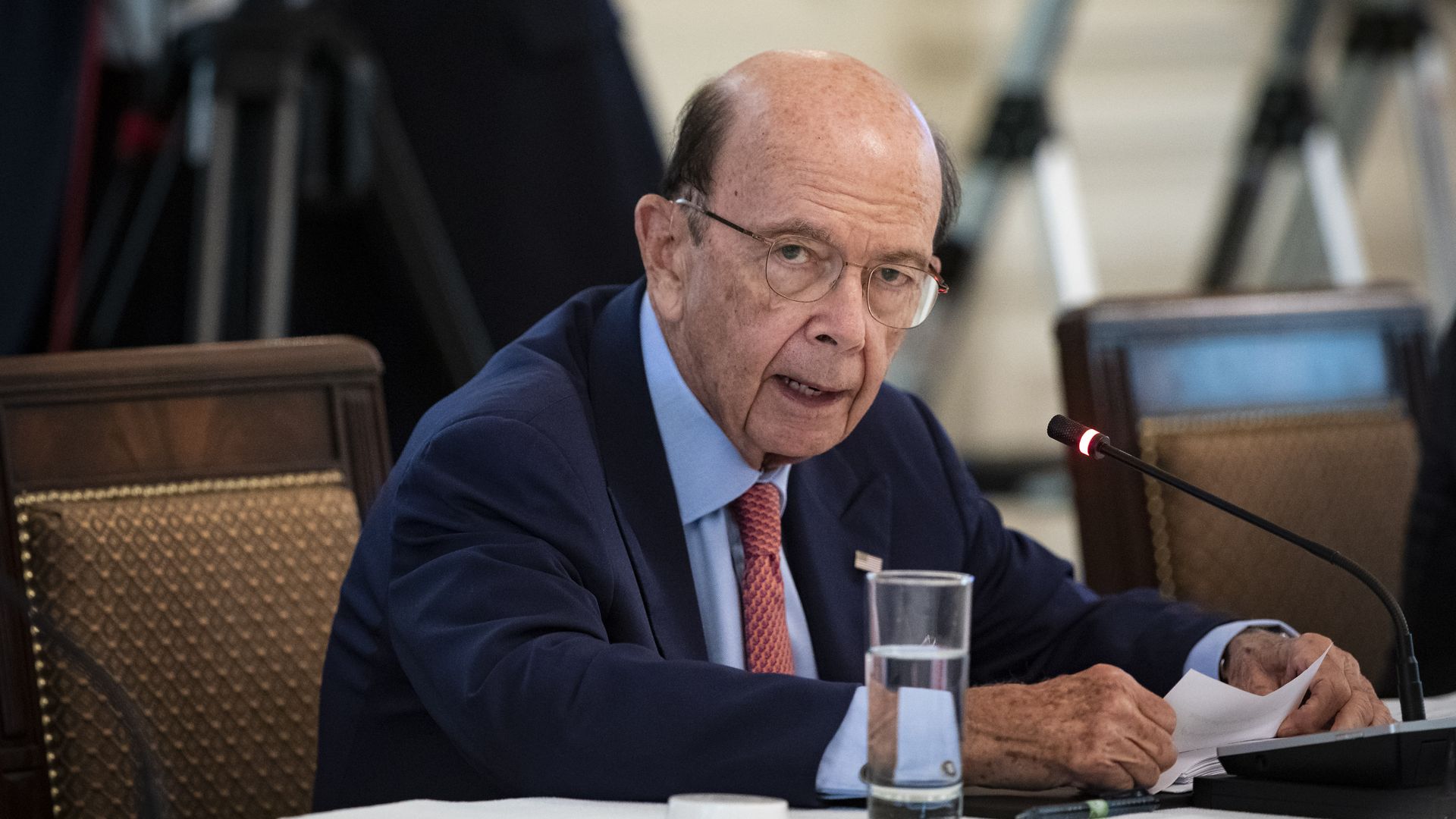 Photo of Wilbur Ross sitting at a table and speaking