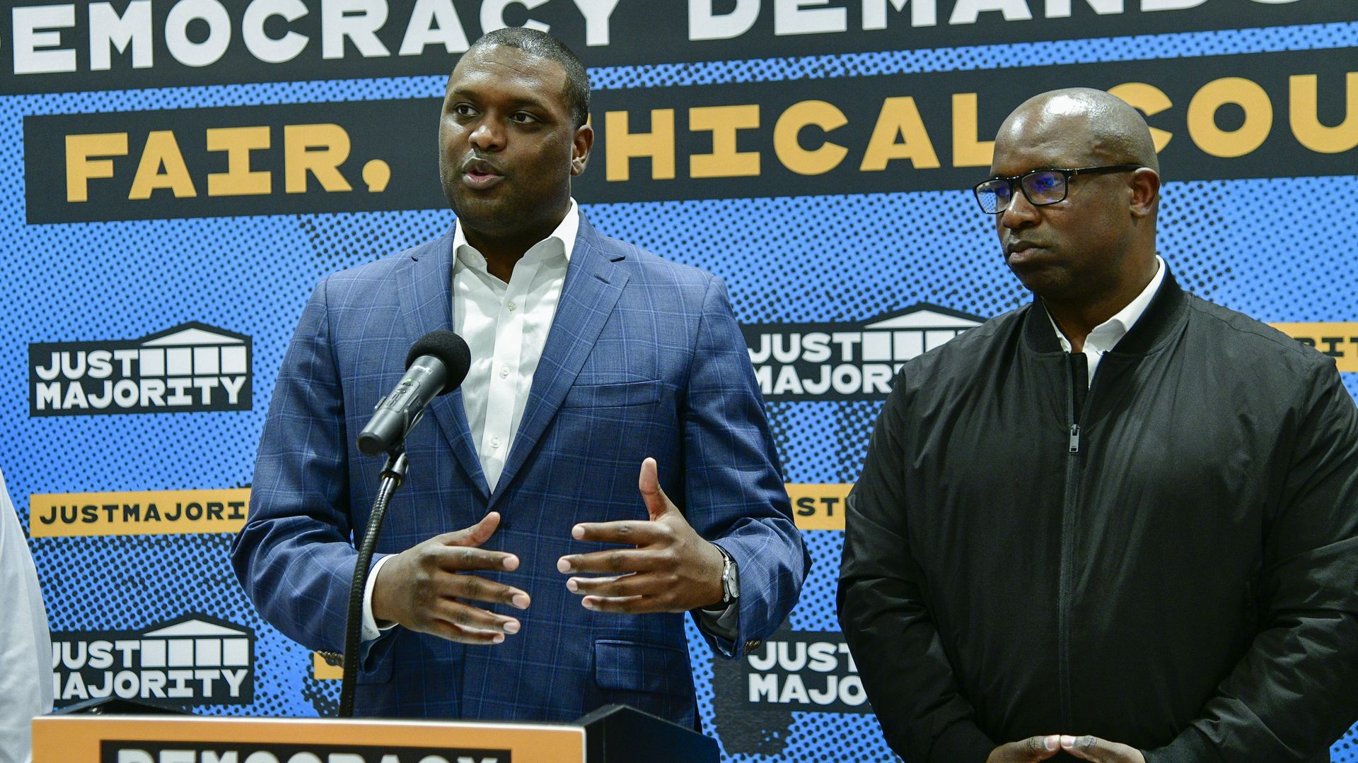 Reps. Mondaire Jones, wearing a blue suit, and Jamaal Bowman, wearing a black jacket.