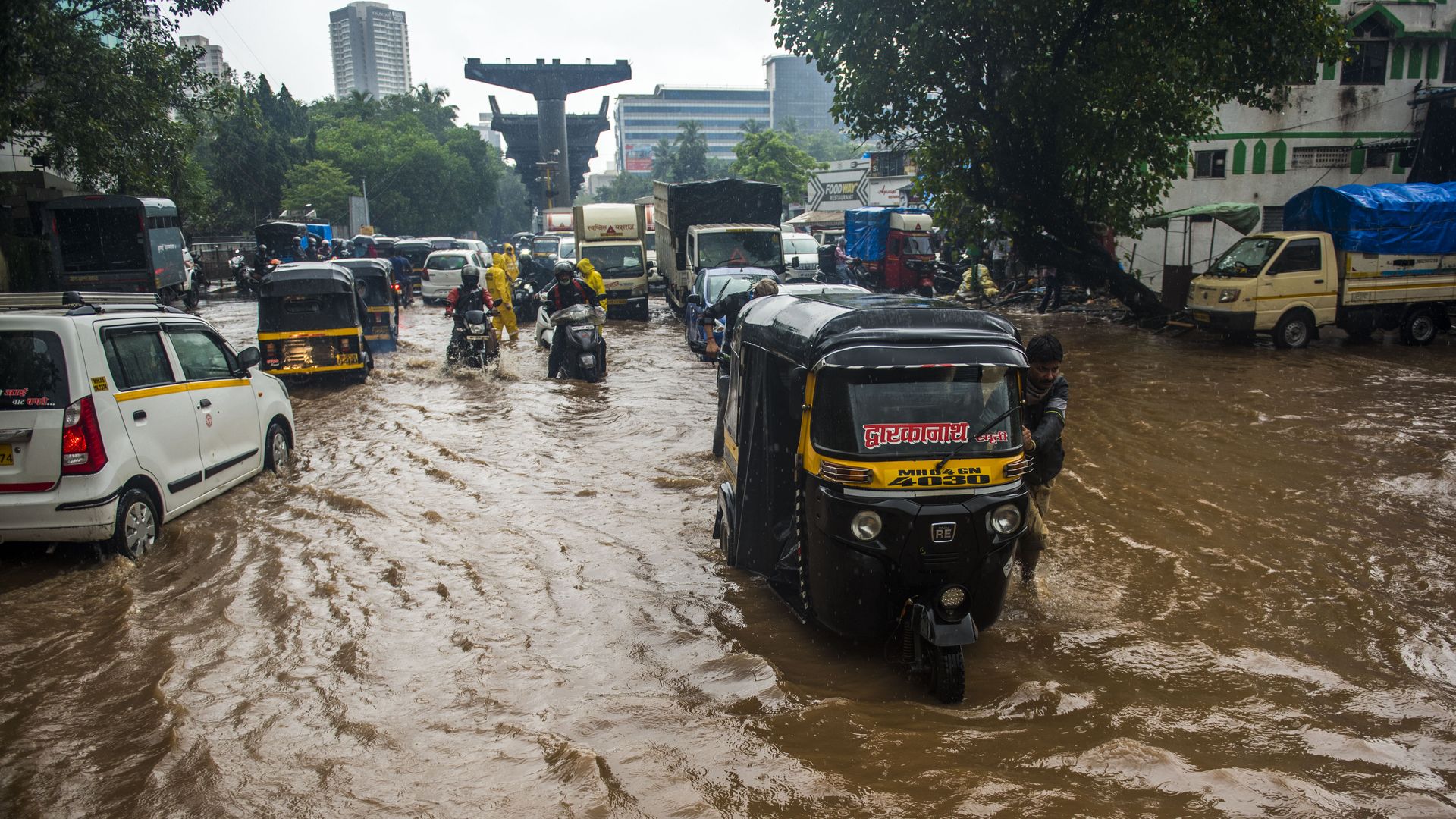 Vehicles driving through a flooded street in Mumbai on July 19.