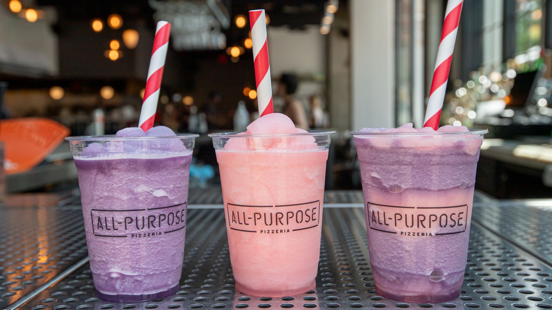 Two purple and one pink slushie drink 