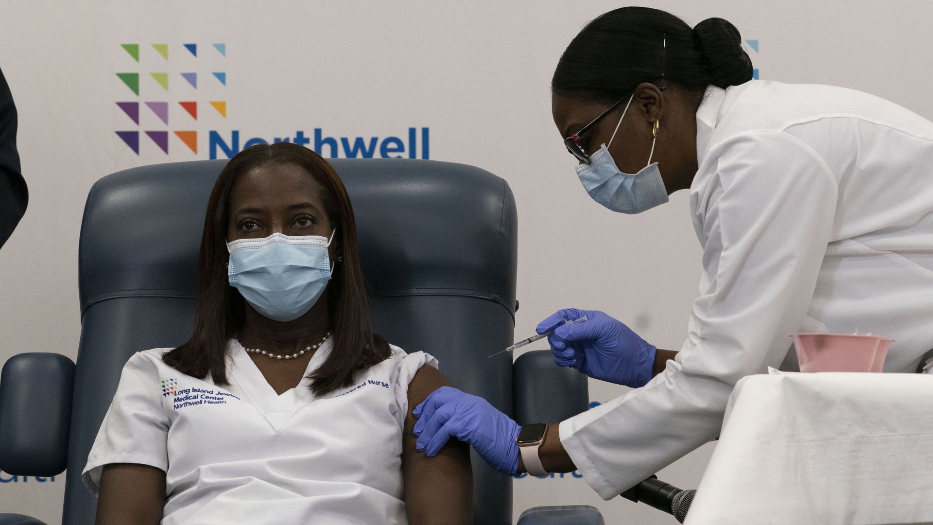 A health care worker receives a coronavirus vaccine.