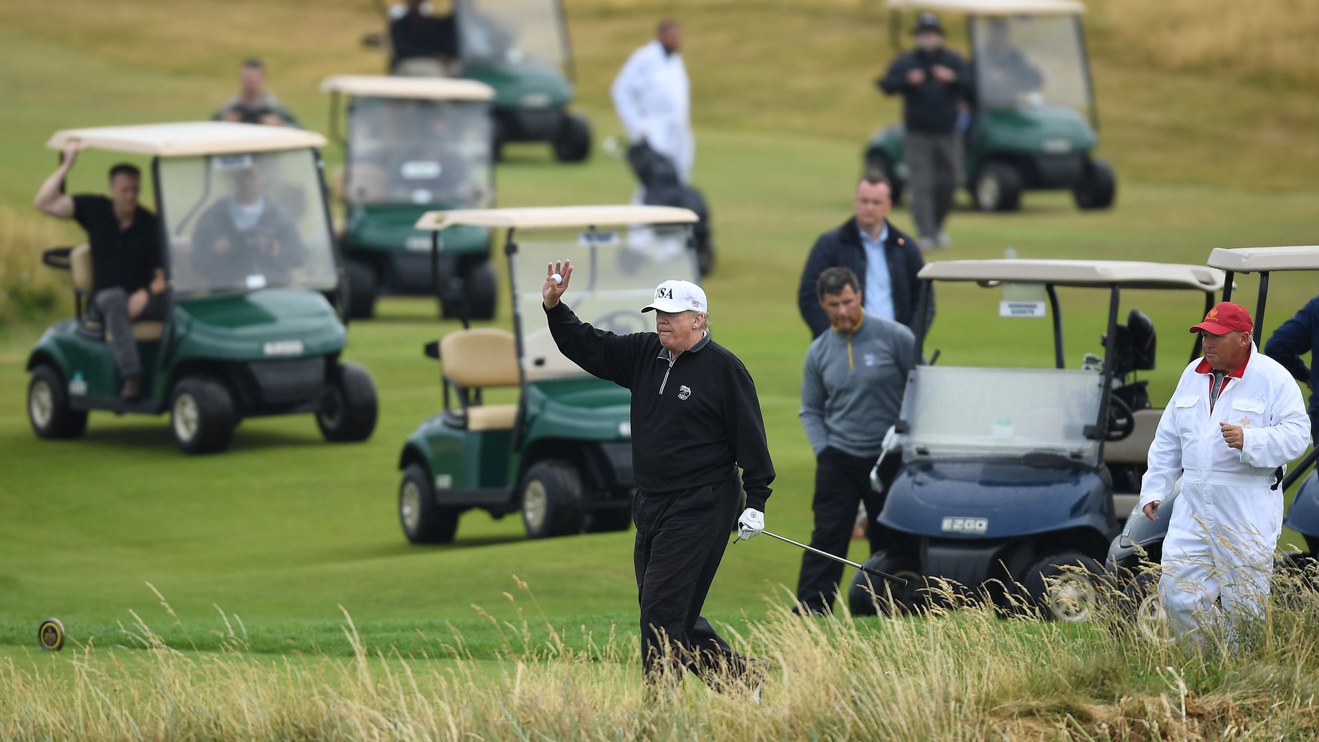 President Donald Trump waves whilst playing a round of golf at Trump Turnberry Luxury Collection Resort d