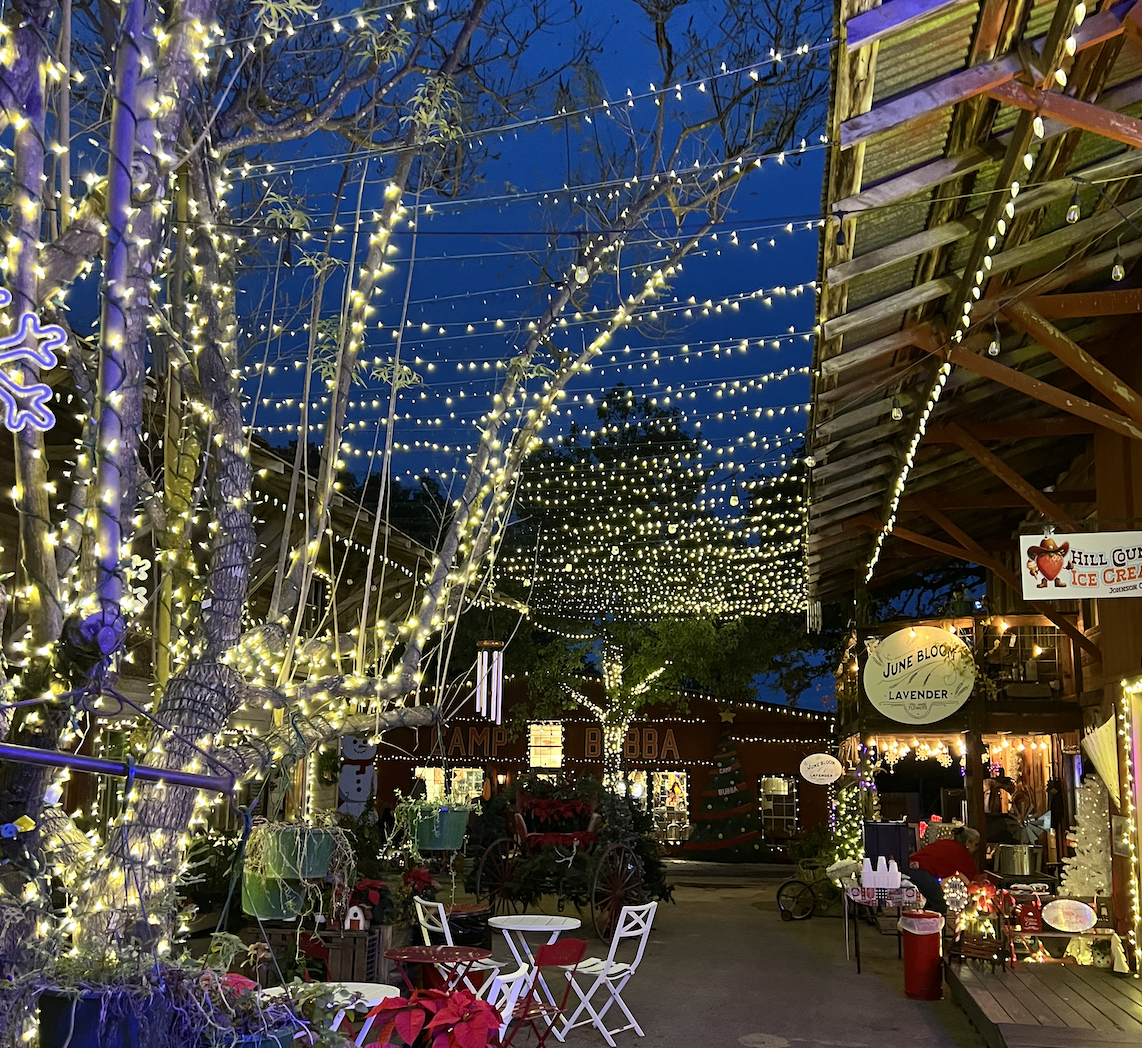 A photo of a courtyard with holiday lights.