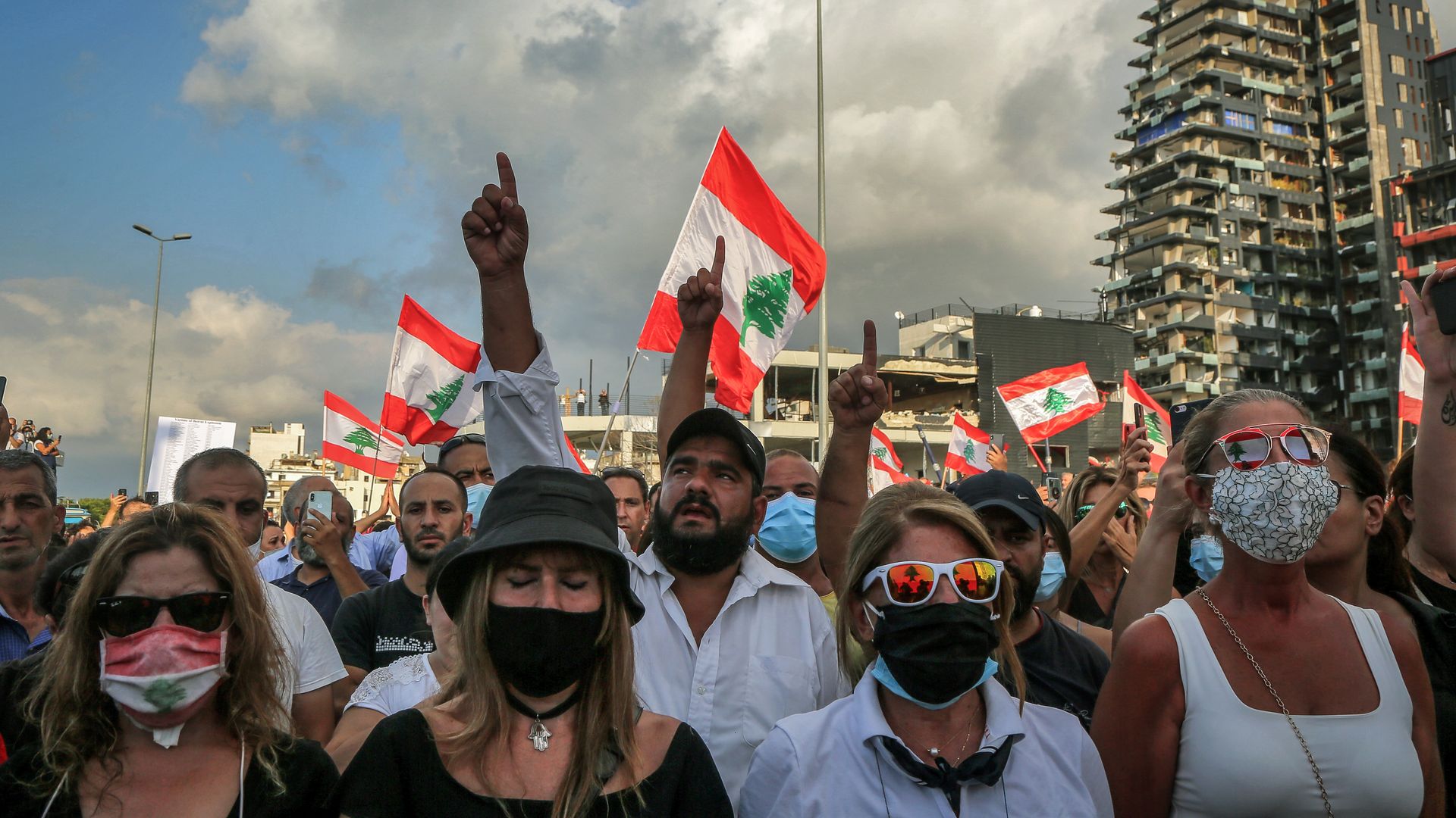 Anti-government activists take part in a ceremony to commemorate the victims of the massive Beirut's port explosion